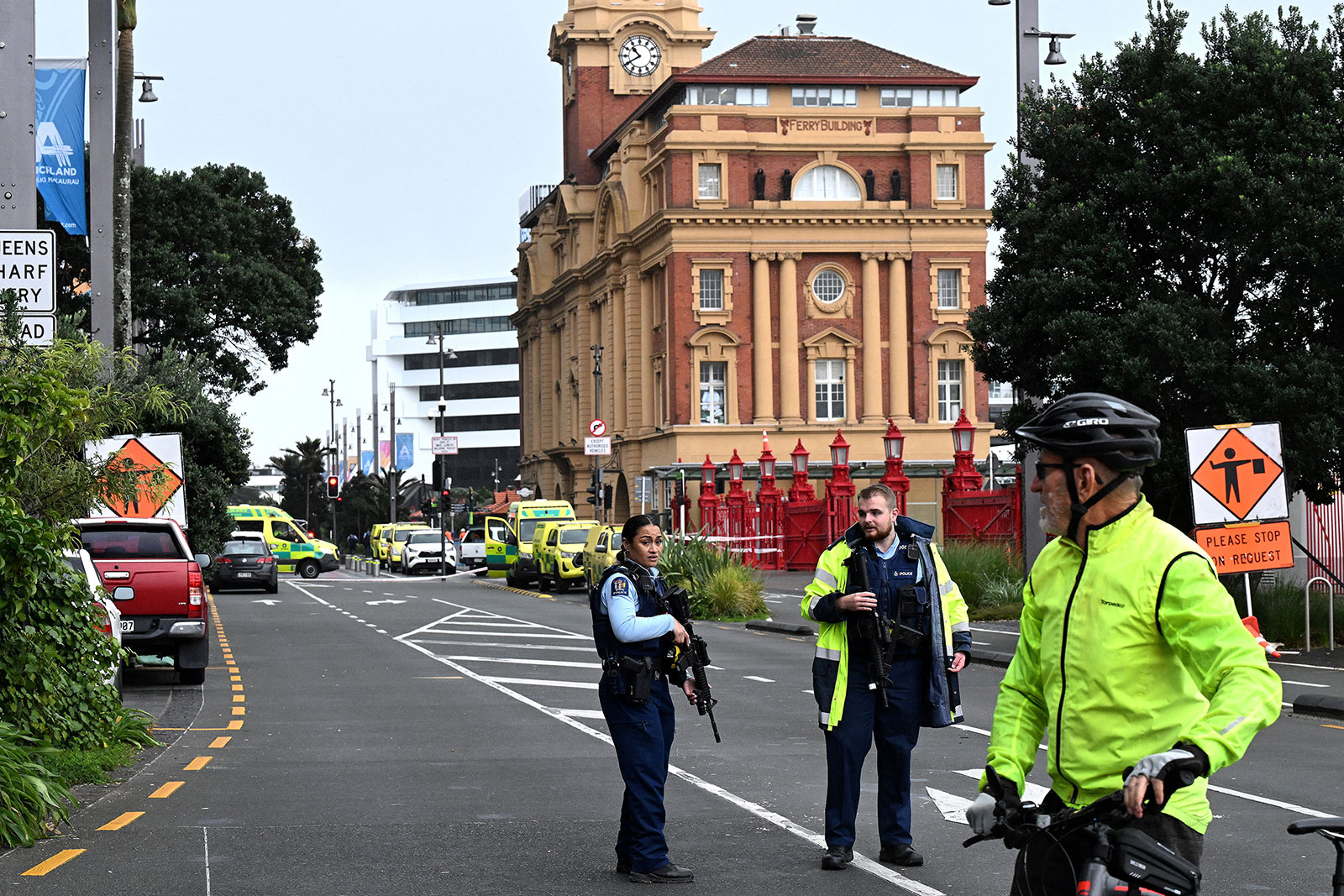 Police officers stand guard near the site of a shooting in central Auckland on July 20.