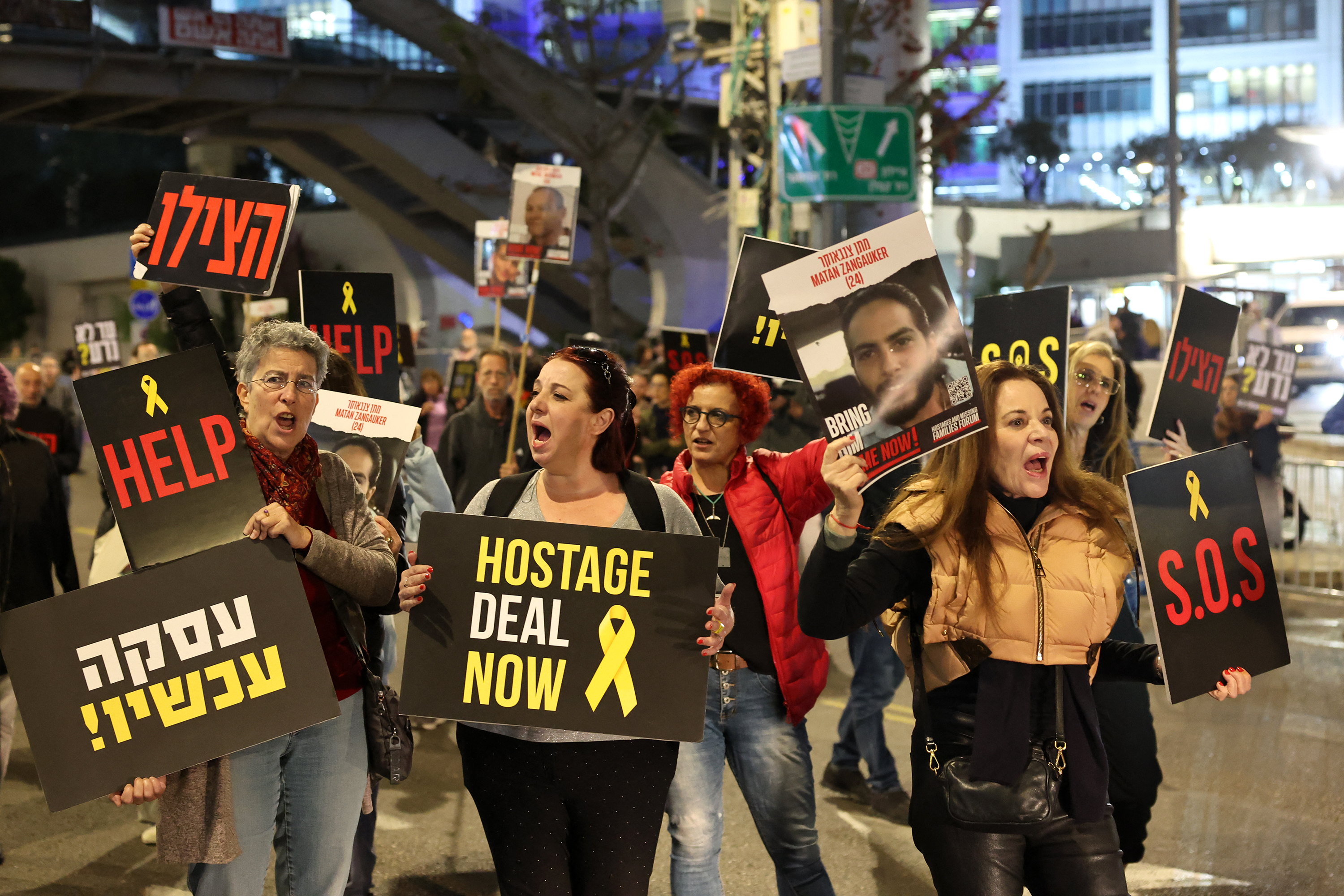 Relatives and supporters of Israeli hostages held in Gaza hold signs during a demonstration in Tel Aviv, Israel, on March 26. 