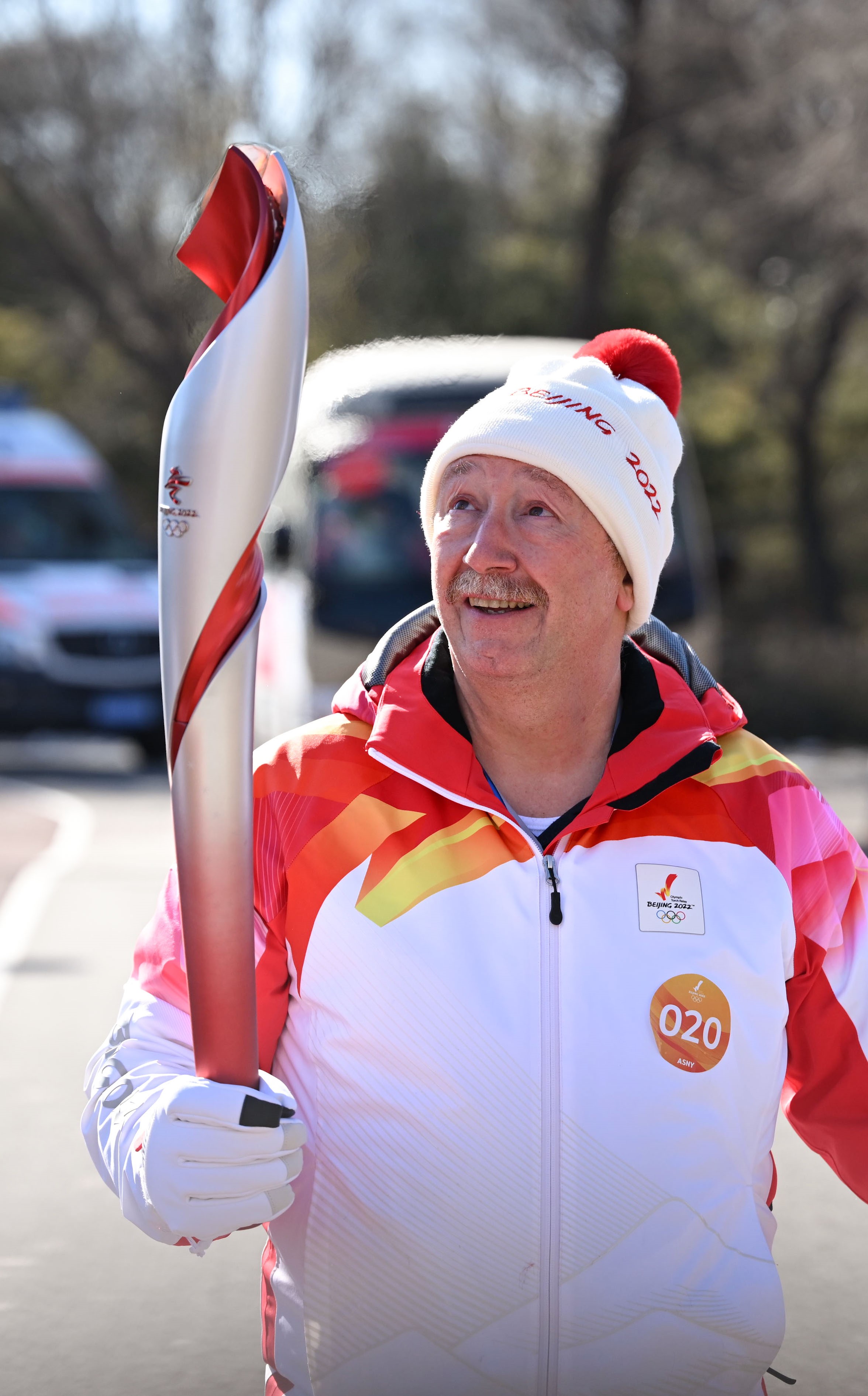 Marc Ventouillac runs with the torch during the Beijing 2022 Olympic Torch Relay at the Olympic Forest Park in Beijing Feb. 4.