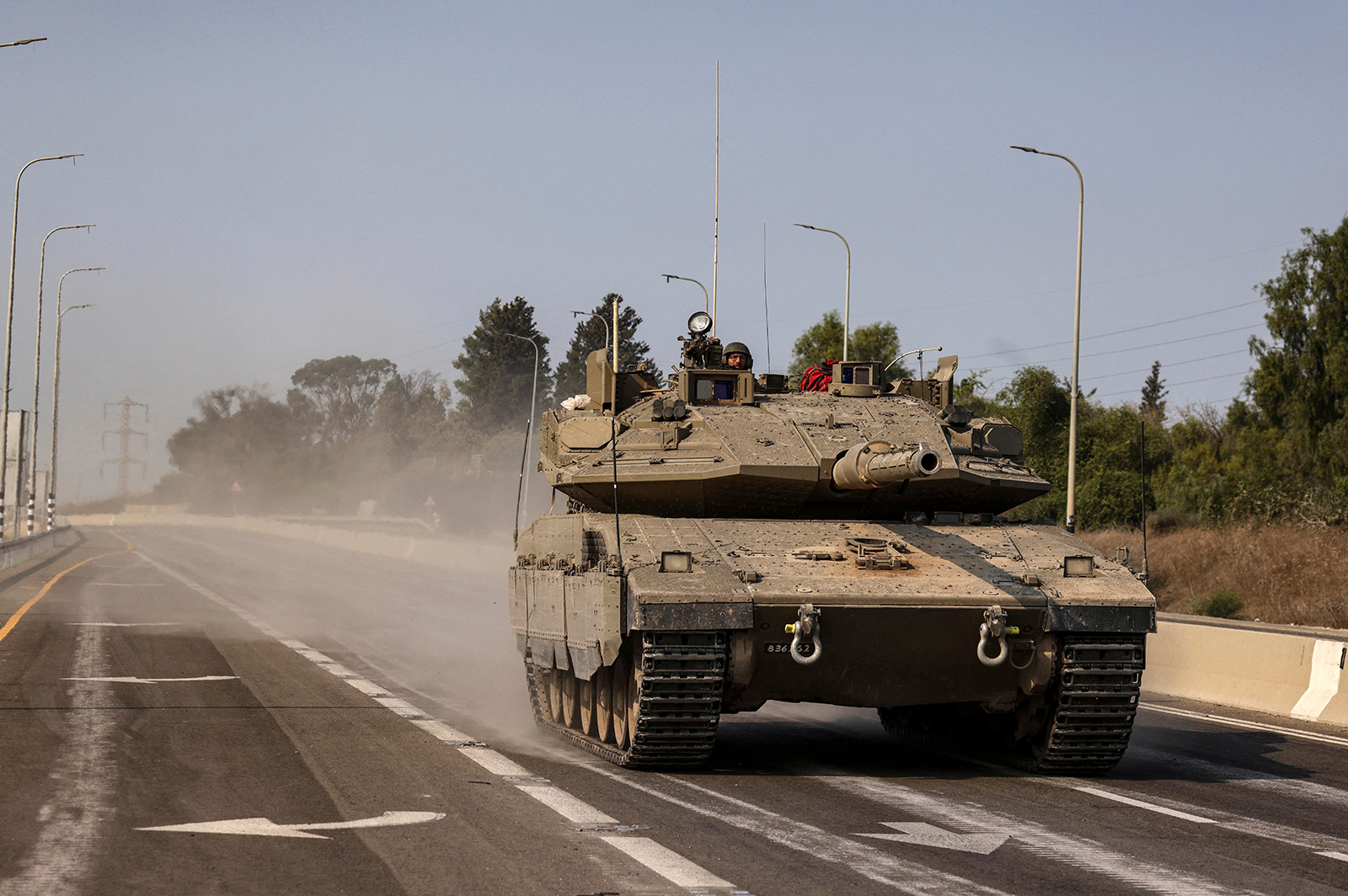 An Israeli tank travels on a highway near Sderot, Israel, on October 8. 