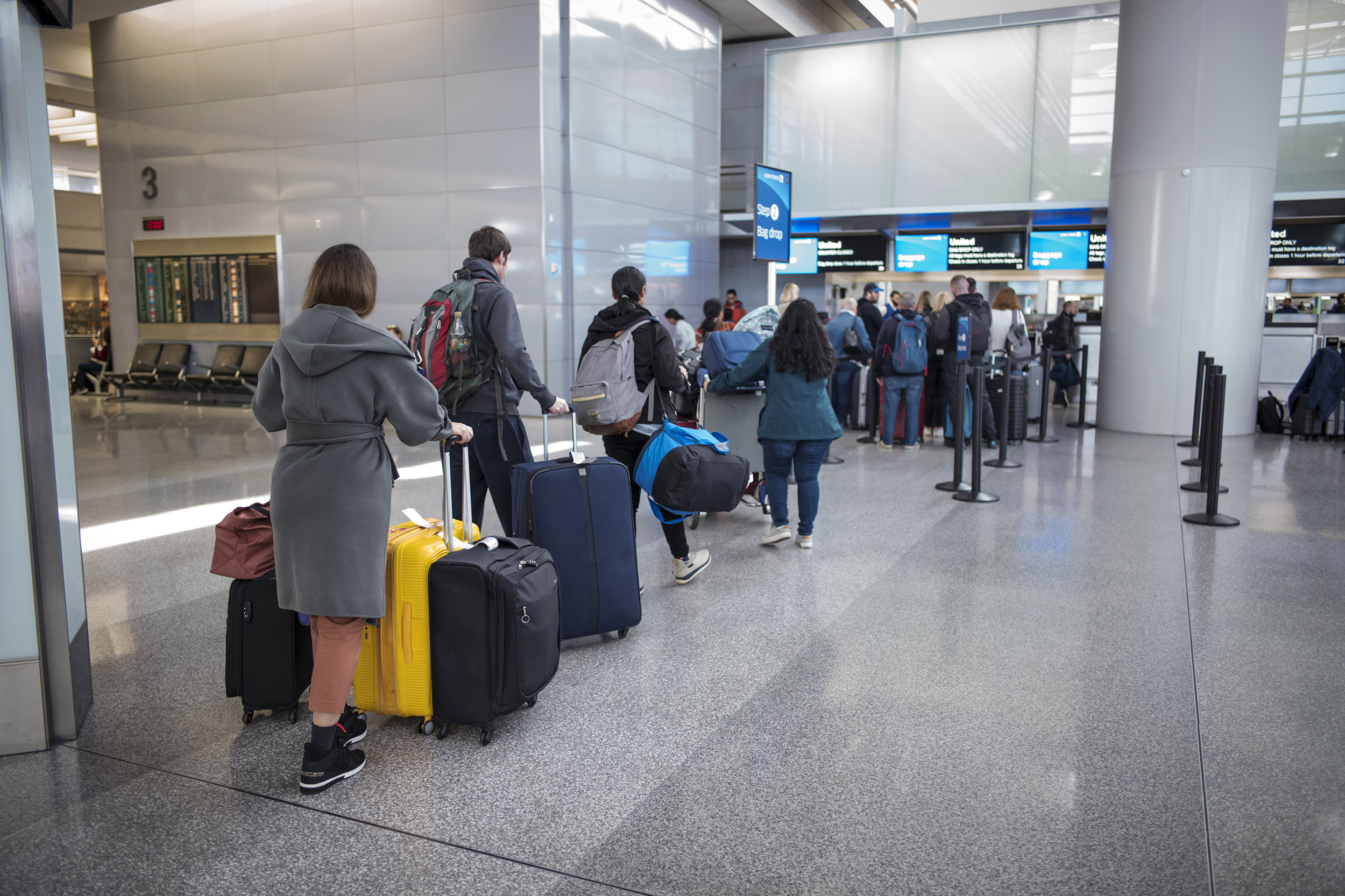 Travelers wait to check their bags at San Francisco International Airport in San Francisco, California, on Friday, January 31, 2020. 