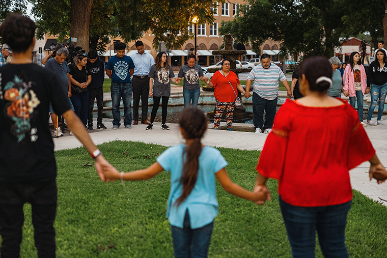 Members of the community gather at the City of Uvalde Town Square for a prayer vigil on Tuesday,  May 24, in Uvalde, Texas. 