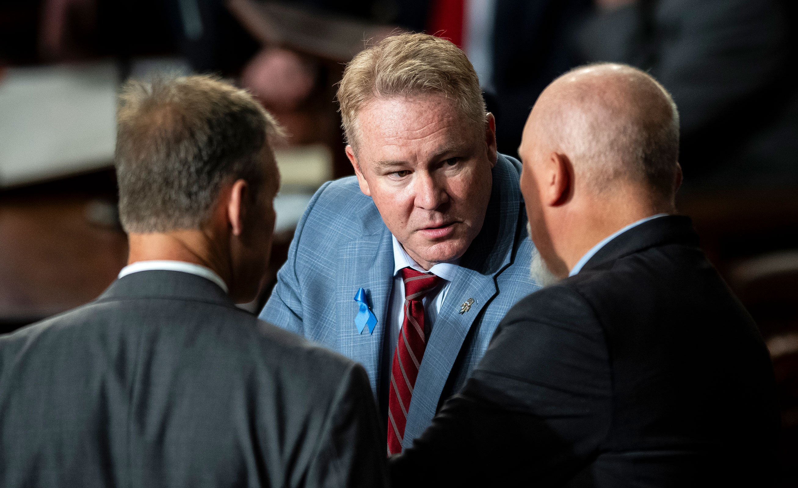 Rep. Warren Davidson, center, speaks with Representative Scott Perry, left, and Representative Chip Roy, right, before a second round of voting for Speaker of the House begins, in the House Chamber, at the Capitol, in Washington, DC, on Wednesday, October 18. 