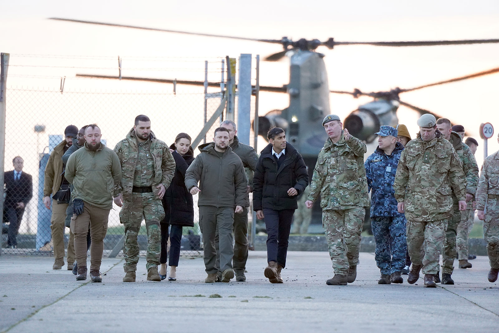 British Prime Minister Rishi Sunak and Ukrainian President Volodymyr Zelensky arrive to meet Ukrainian troops being trained to command Challenger 2 tanks at a military facility on February 8 at Lulworth Camp in Dorset, England.