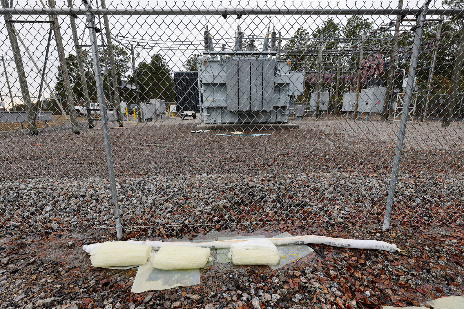 Barriers designed to absorb oil are placed near a damaged transformer in Carthage, North Carolina, on December 4.