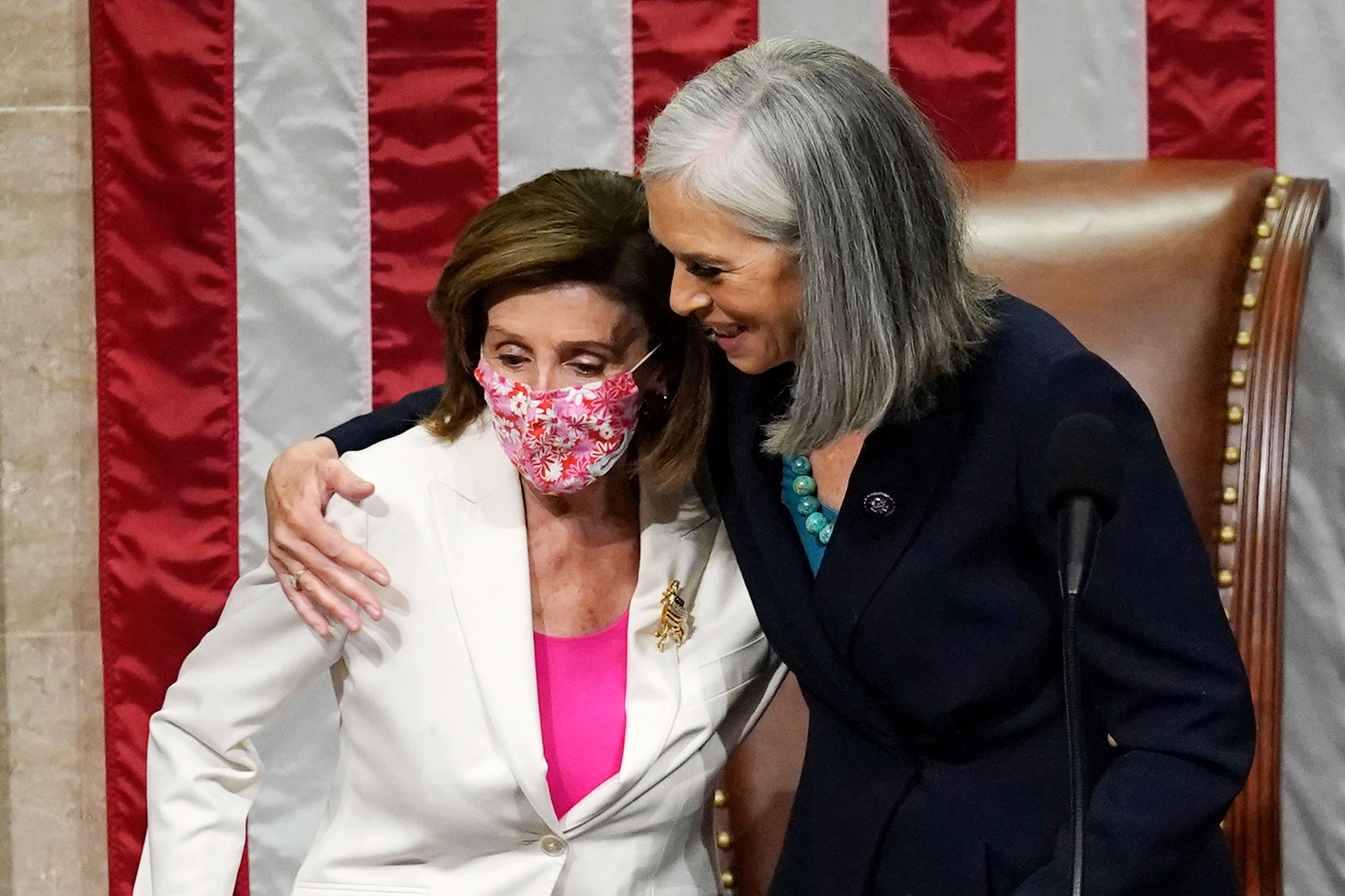 Rep. Katherine Clark, right, hugs House Speaker Nancy Pelosi after the House passage of President Joe Biden's spending bill at the Capitol on November 19.