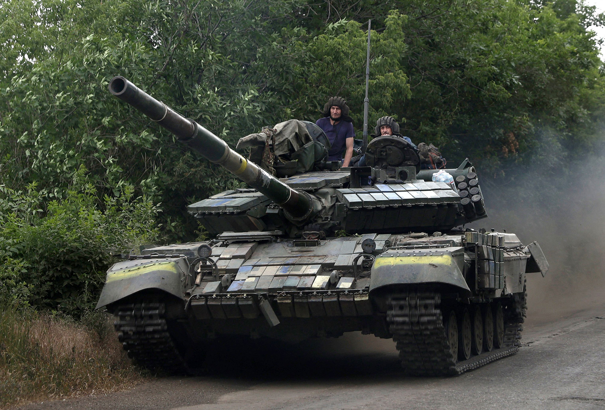 Ukrainian soldiers ride a tank on a road in the eastern Luhansk region, Ukraine, on June 23.