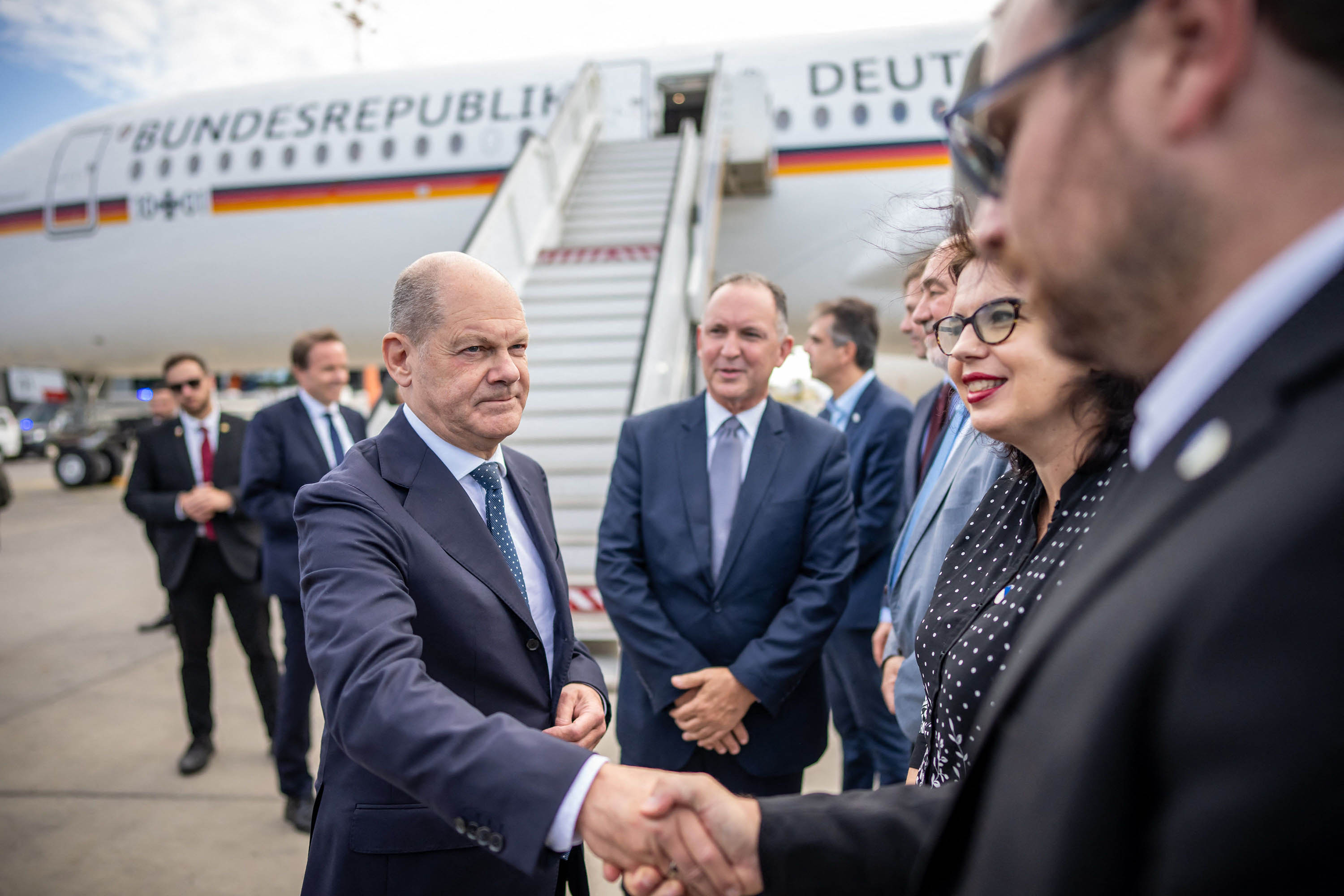 German Chancellor Olaf Scholz, center, shakes hands with delegation members after landing at the Ben Gurion airport in Tel Aviv, Israel, on October 17. 