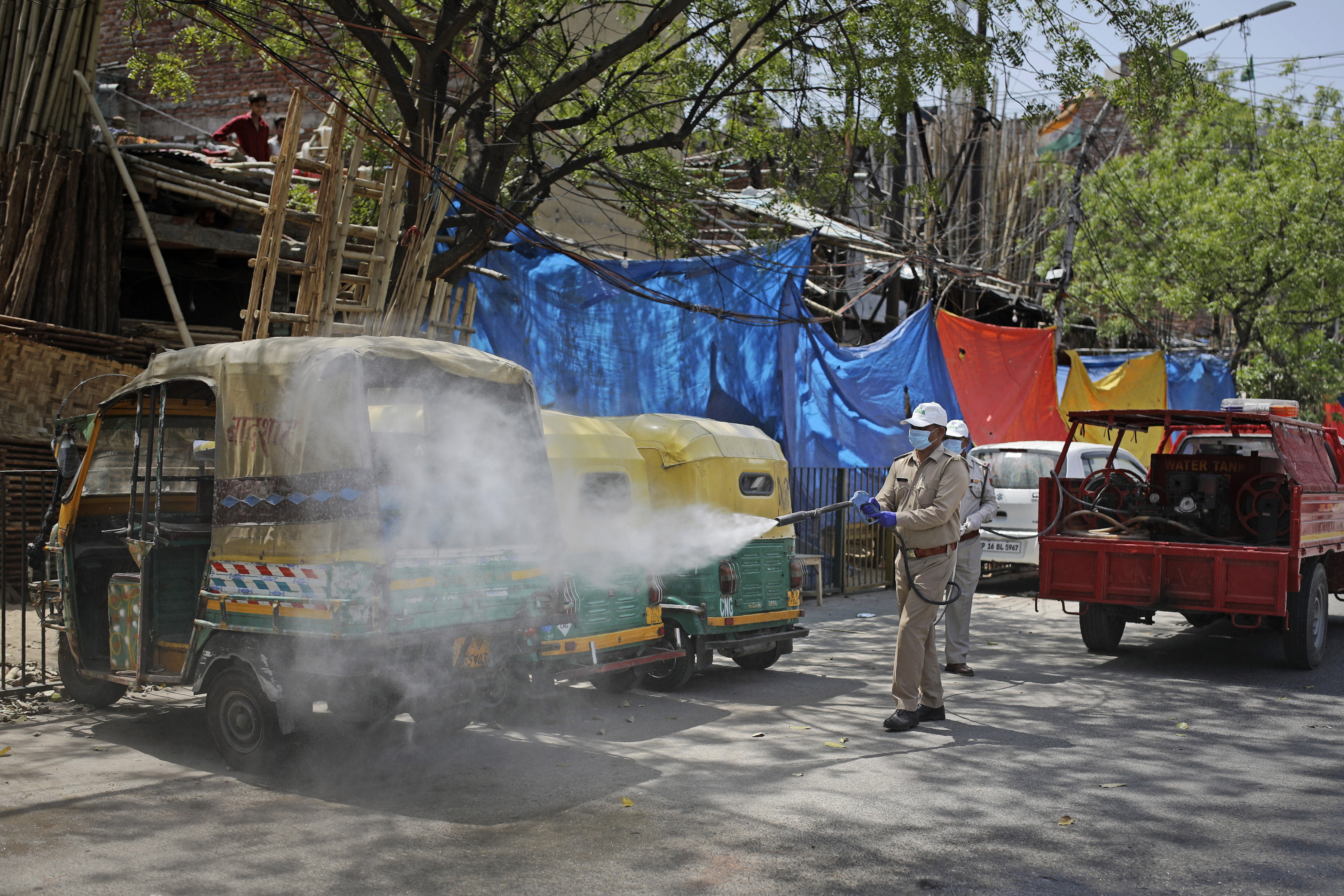 Fire brigade personnel sanitize an area following suspected cases of Covid-19 in Noida, a suburb of New Delhi, India, on April 8.