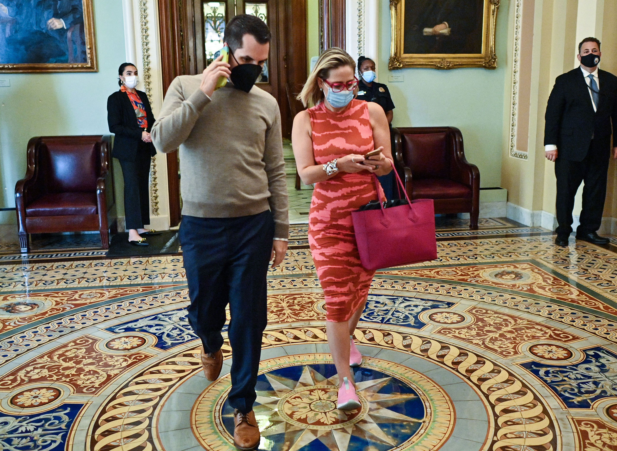 Sen. Kyrsten Sinema walks through the US Capitol on Thursday.