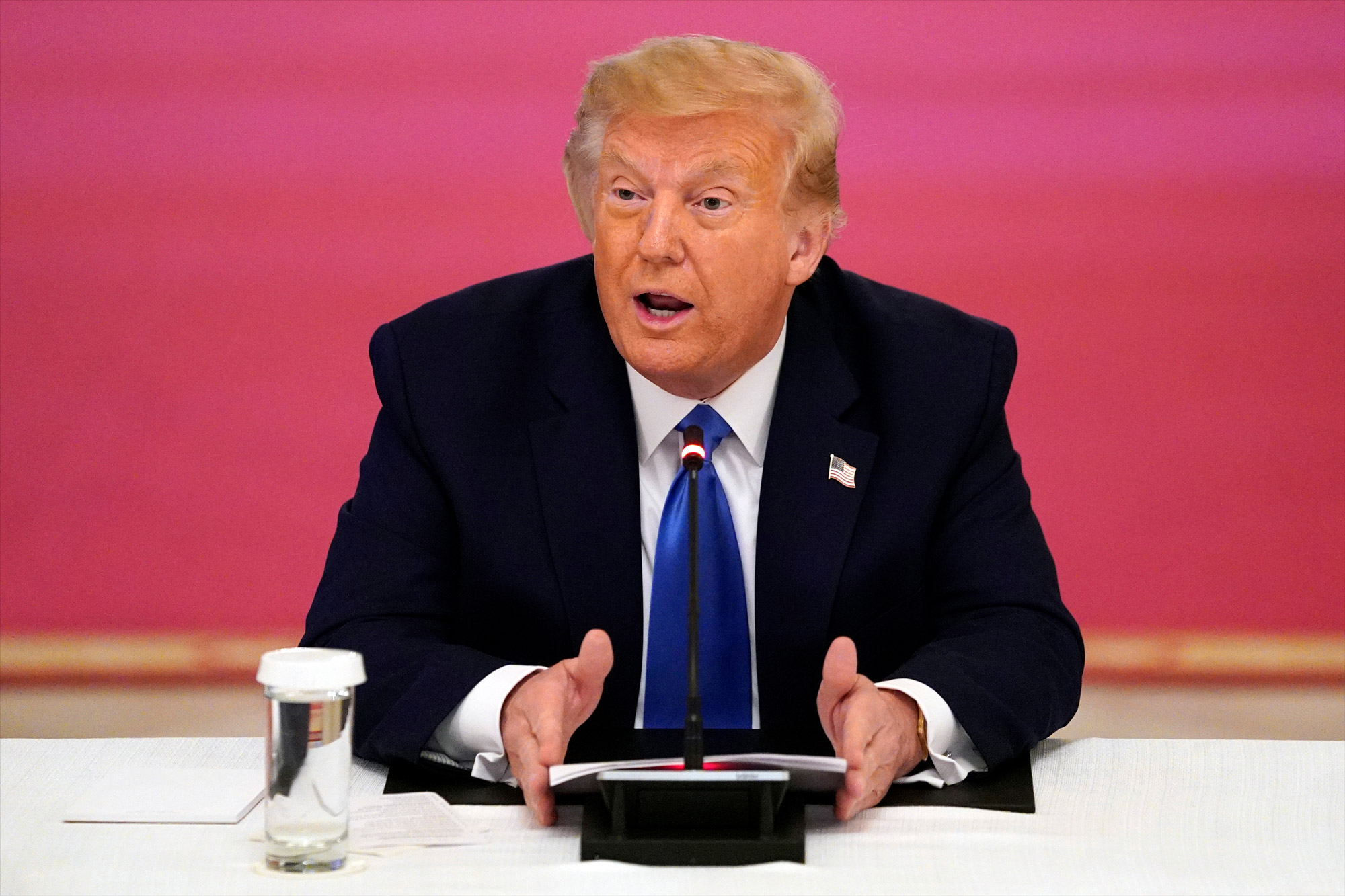 President Donald Trump answers questions from reporters during a roundtable with people positively impacted by law enforcement on July 13 in Washington.