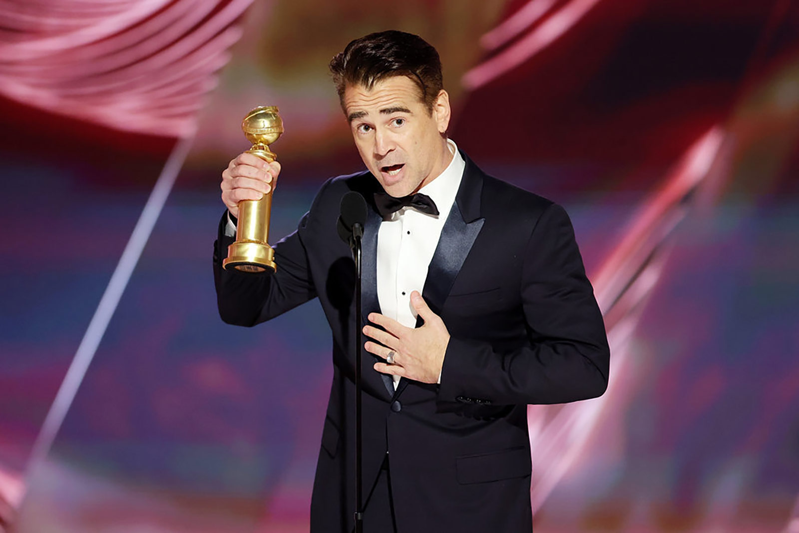 Colin Farrell accepts his award. 