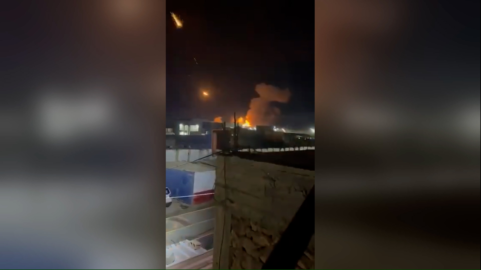 A screengrab from a video, geolocated by CNN to the town of Qaim, Iraq, shows the aftermath of US military strikes in the area according to the Iraqi Military. An apparent weapons depot has been hit, and a number of flares from projectiles are seeing rocketing into the sky.
