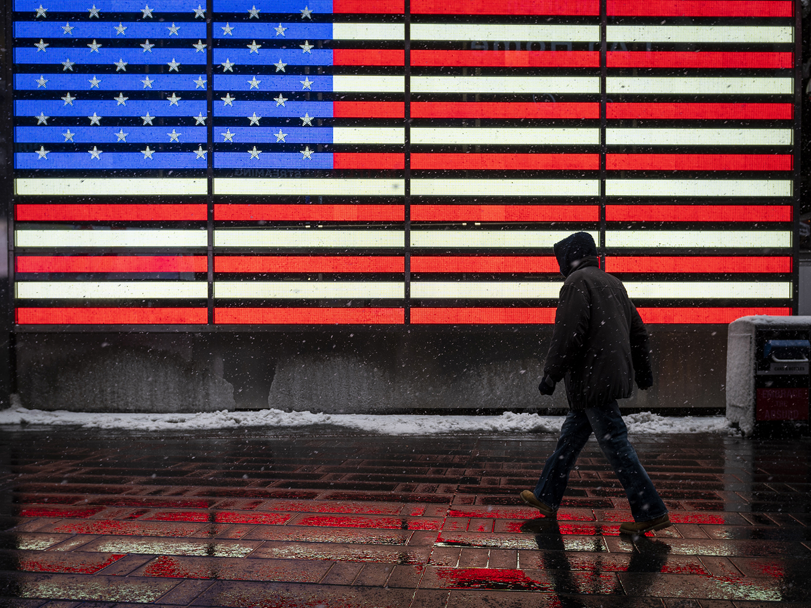 A pedestrian walks through Times Square during a winter storm in New York on Friday, February 19.