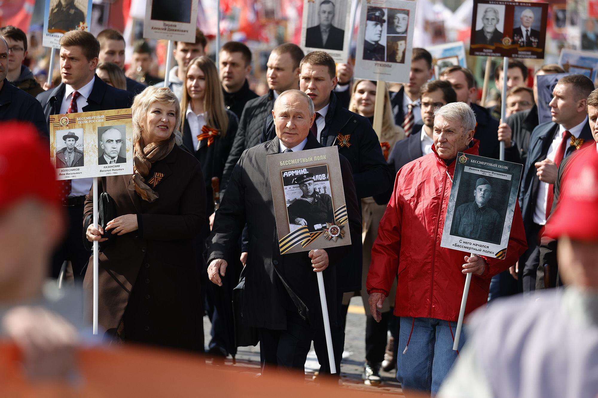 Russian President Vladimir Putin, center, holds a portrait of his father during the Immortal Regiment walk during the Victory Day celebrations at Red Square, Moscow, Russia, on May 9. 