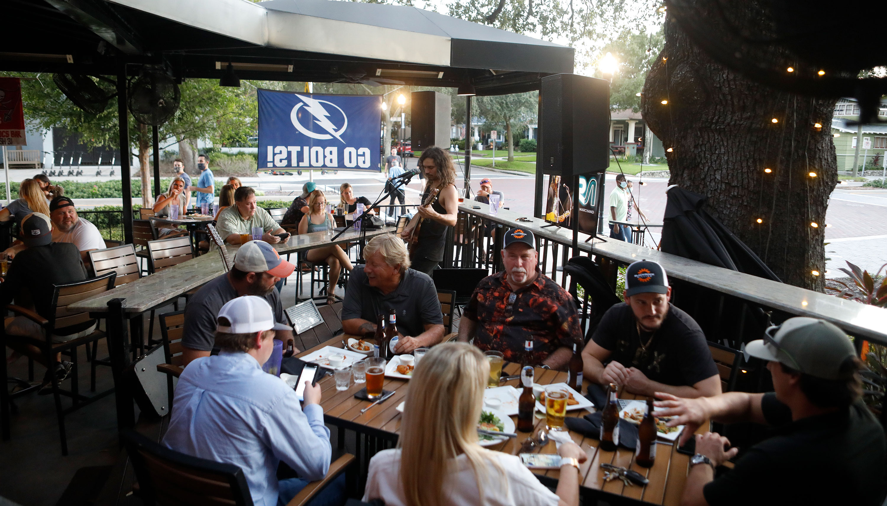 Patrons eat dinner at Irish 31 on the first day of full capacity seating on September 25 in Tampa, Florida. 