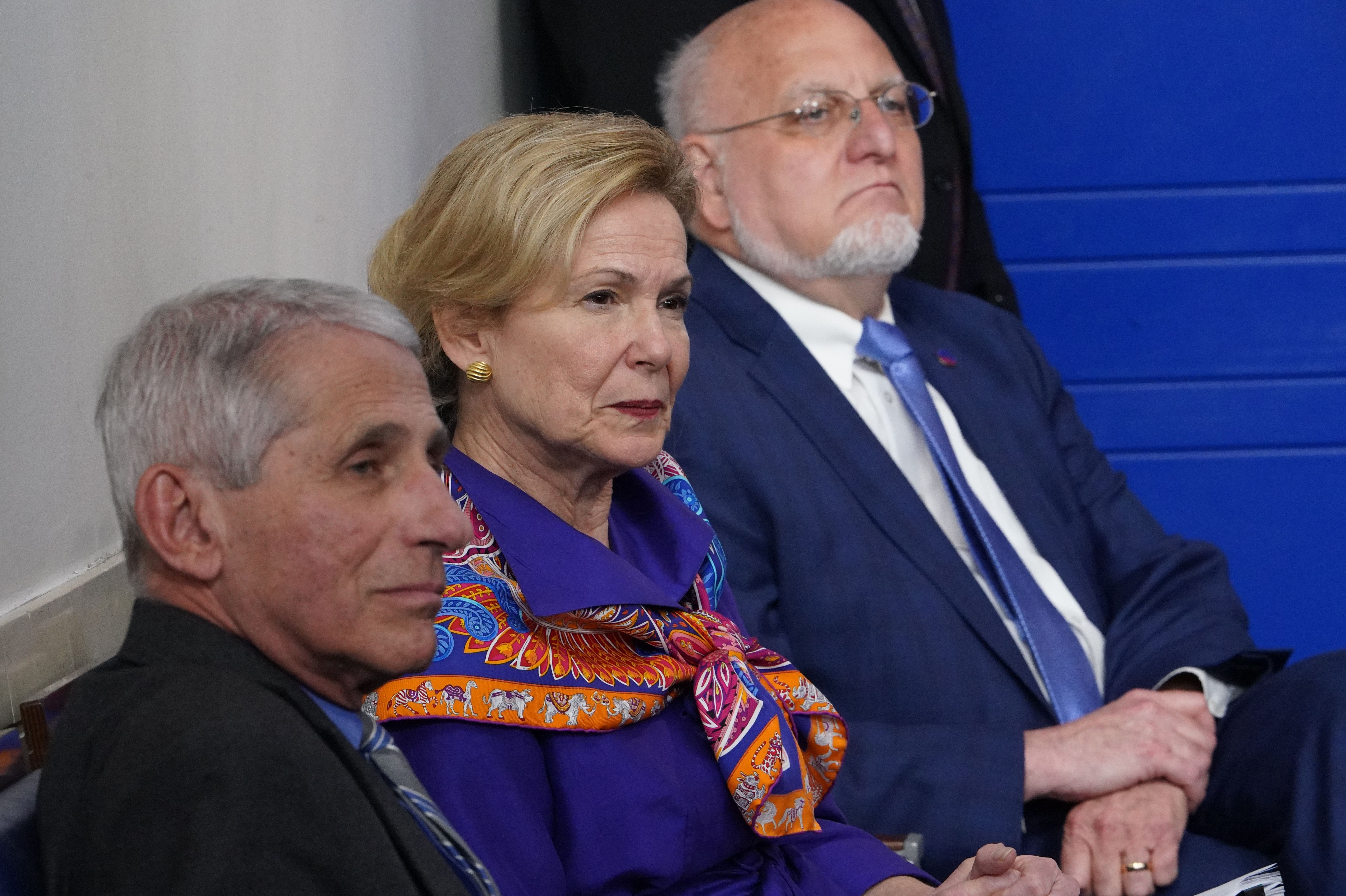 Members of President Donald Trump's coronavirus task force listen during a briefing at the White House on April 8. From left are Dr. Anthony Fauci, director of the National Institute of Allergy and Infectious Diseases; Dr. Deborah Birx, the White House coronavirus response coordinator; and Dr. Robert Redfield, director of the Centers for Disease Control and Prevention.