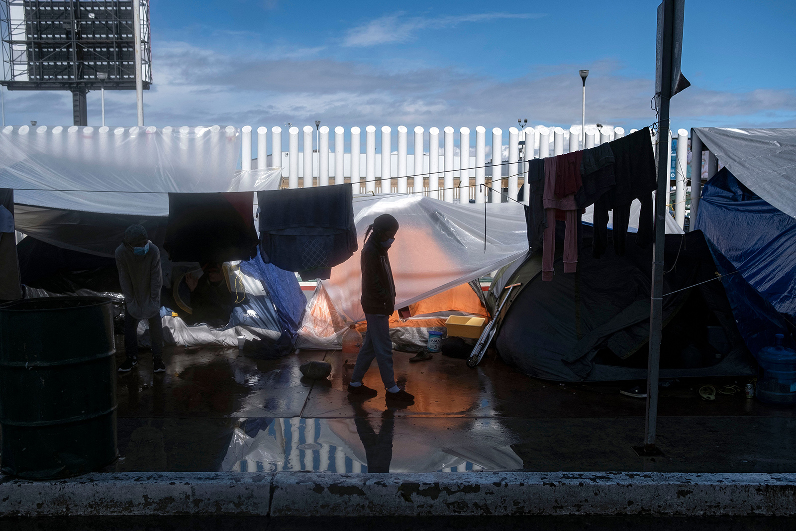 A migrant girl walks at an improvised camp outside El Chaparral crossing port as her and other wait for US authorities to allow them to start their migration process in Tijuana, Baja California state, Mexico, on March 11. 