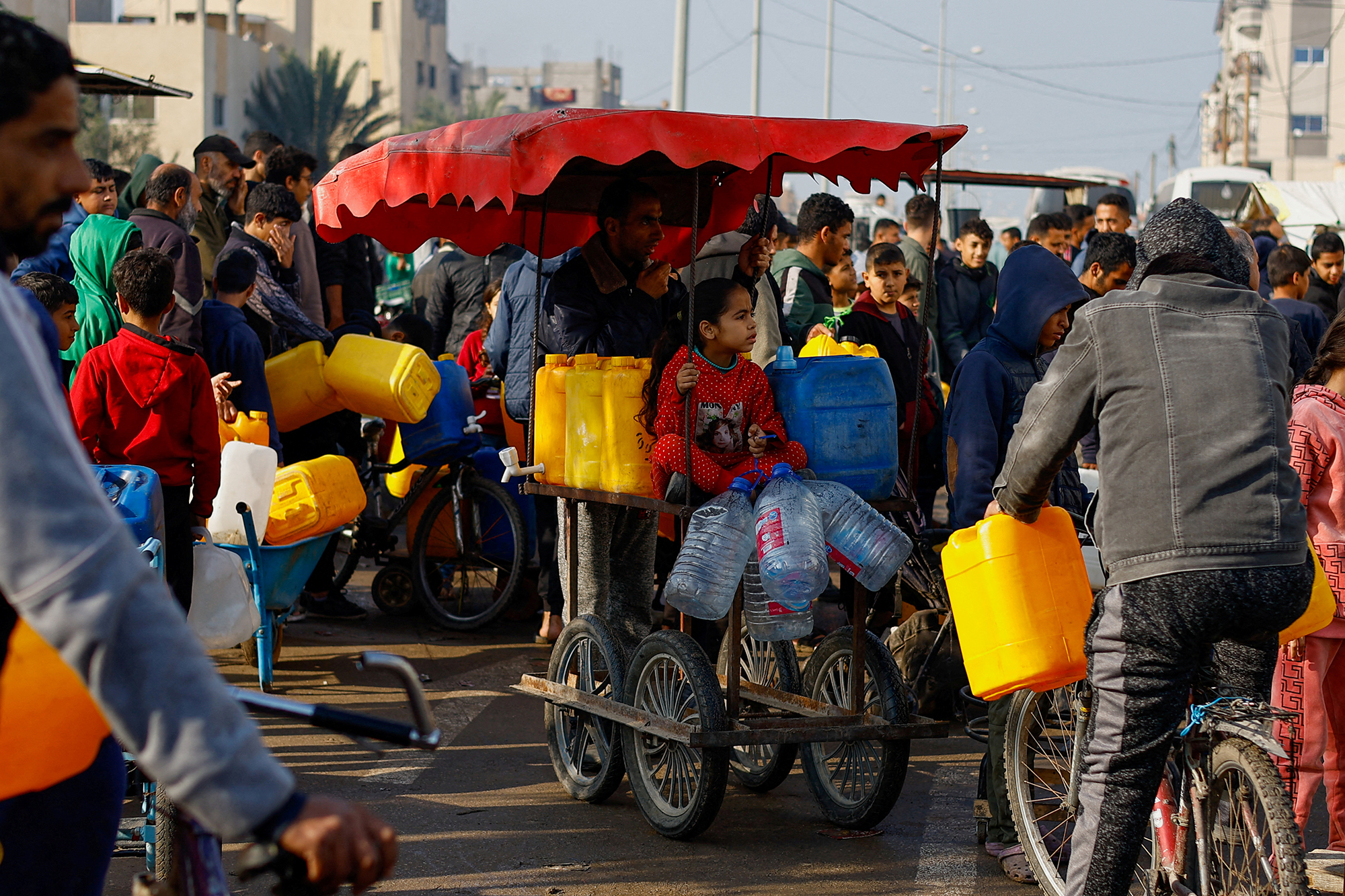 Palestinians wait to collect drinking water in Rafah, Gaza, on January 9.