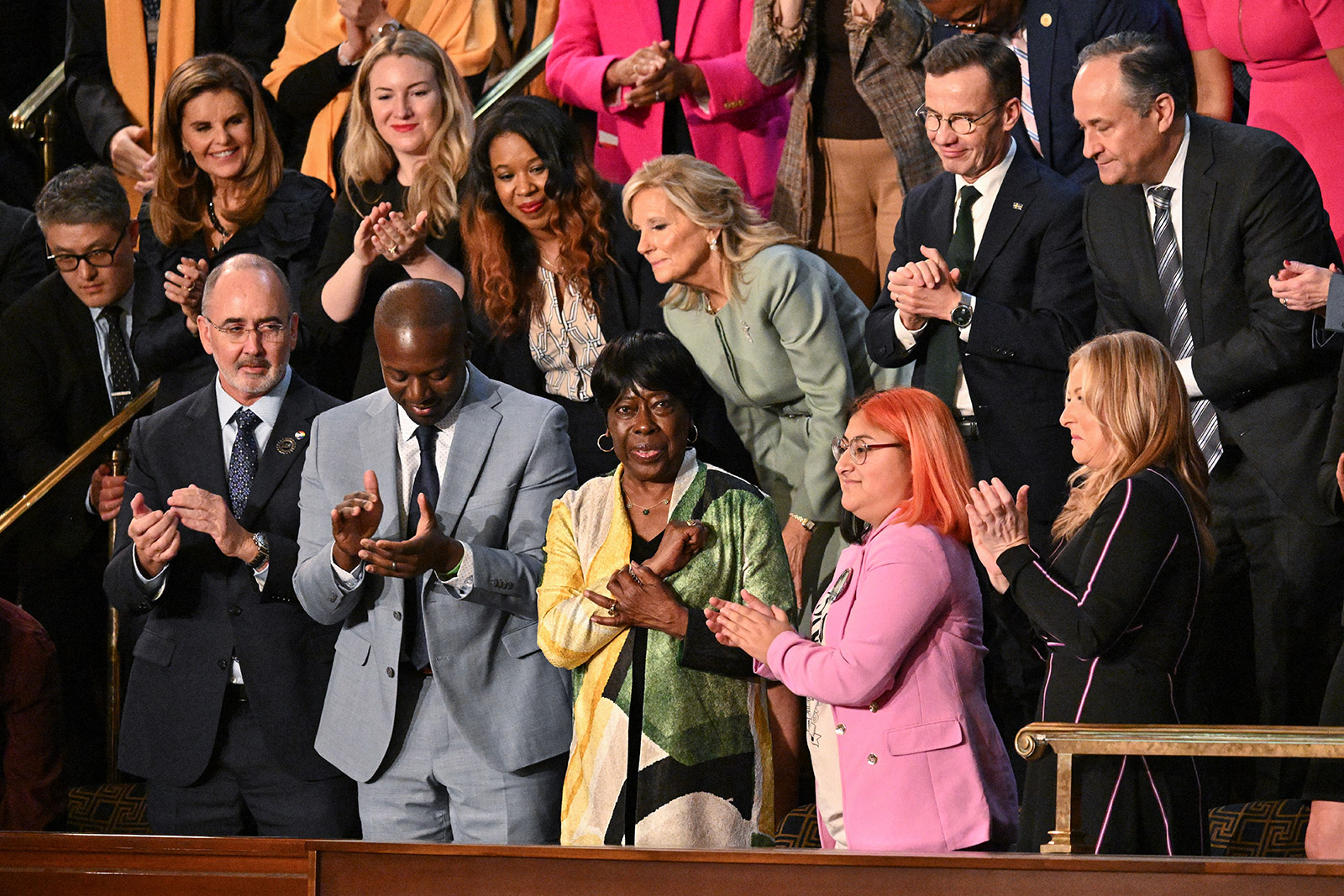 Civil rights activist Bettie Mae Fikes, bottom center, stands as she is recognized by Biden.