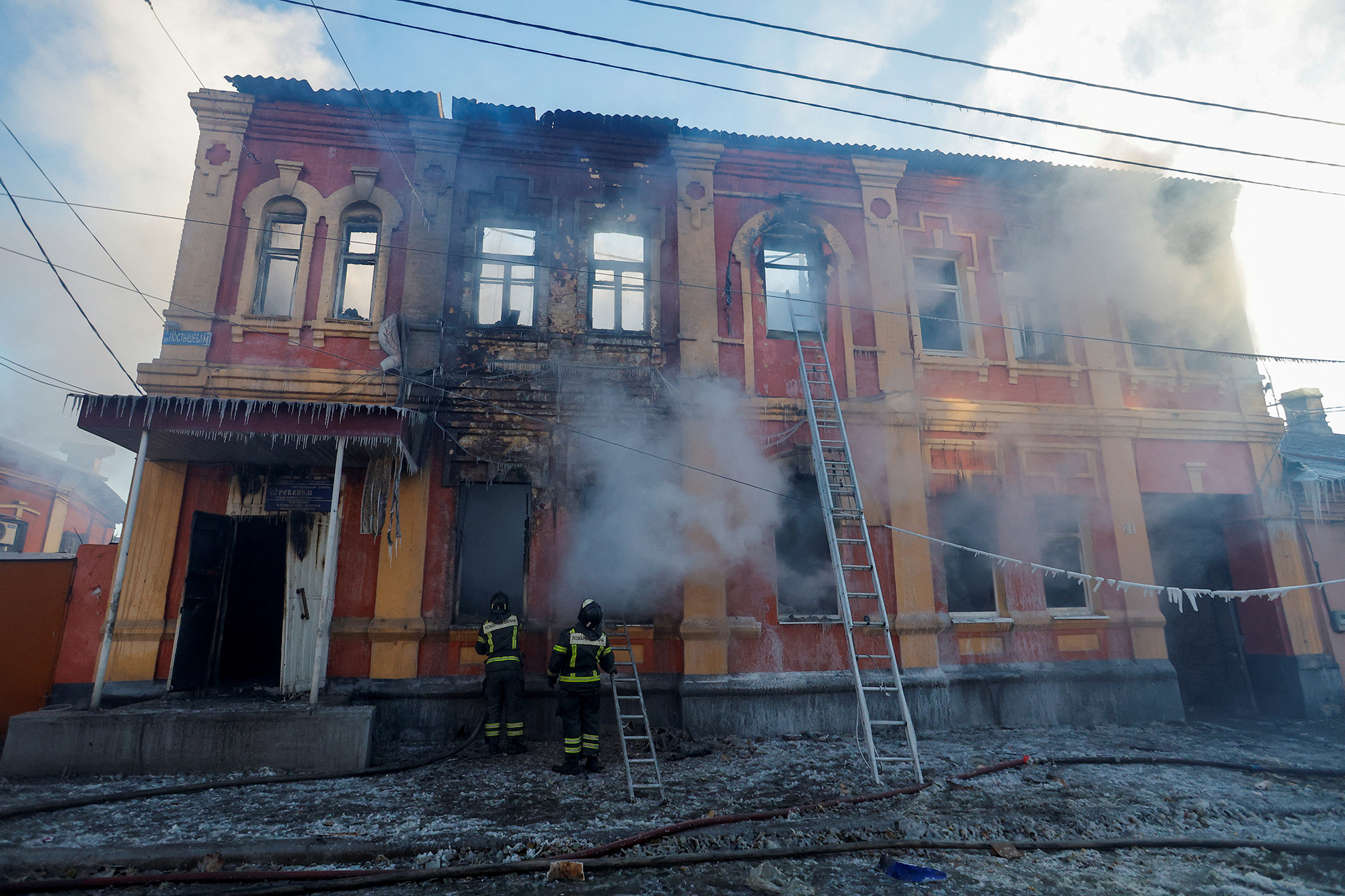 Firefighters work outside an office building destroyed in shelling in Donetsk, Ukraine, on December 5.