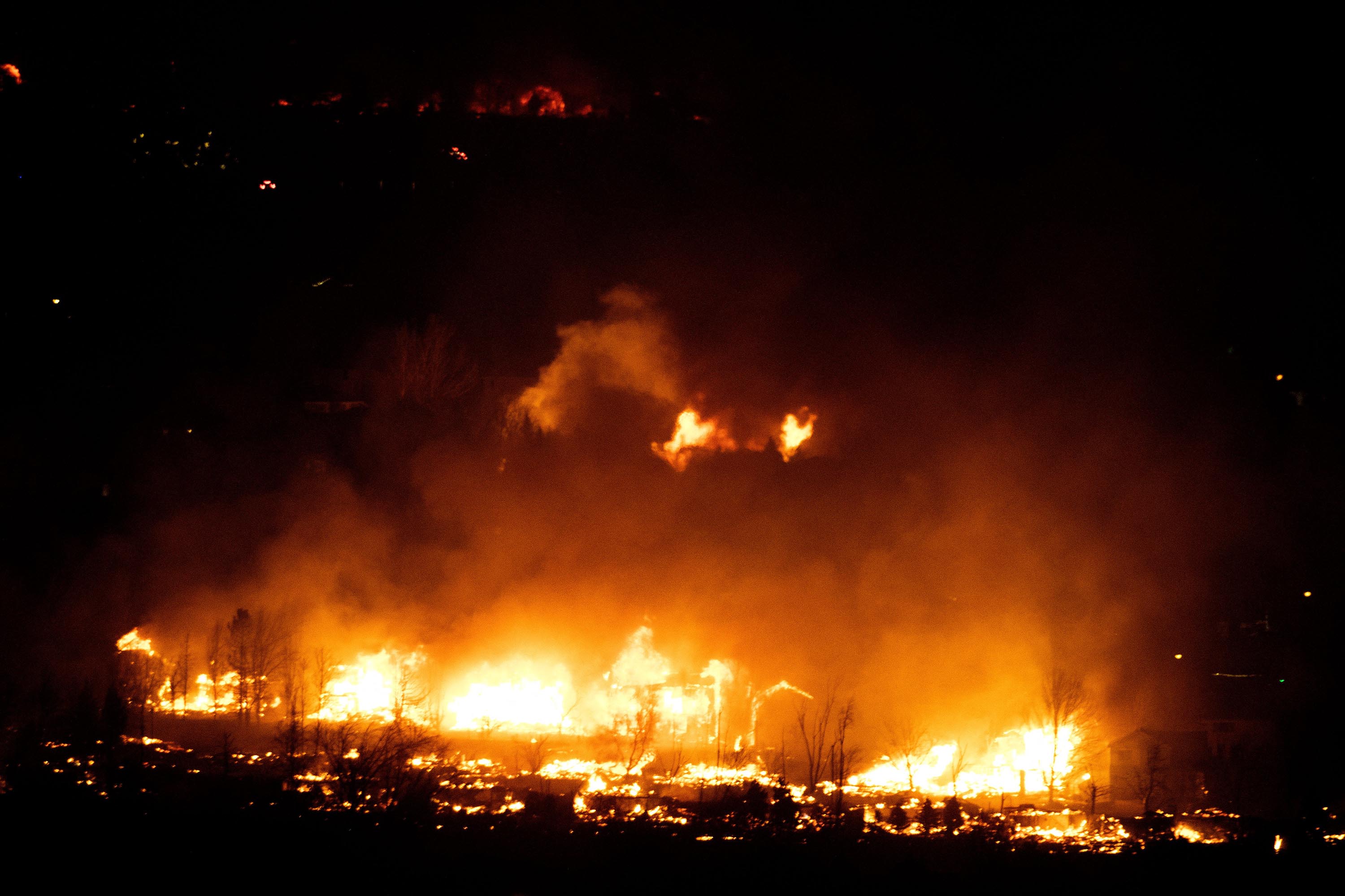 Flames engulf homes as the Marshall Fire spreads through a neighborhood in Boulder County, Colorado on December 30.