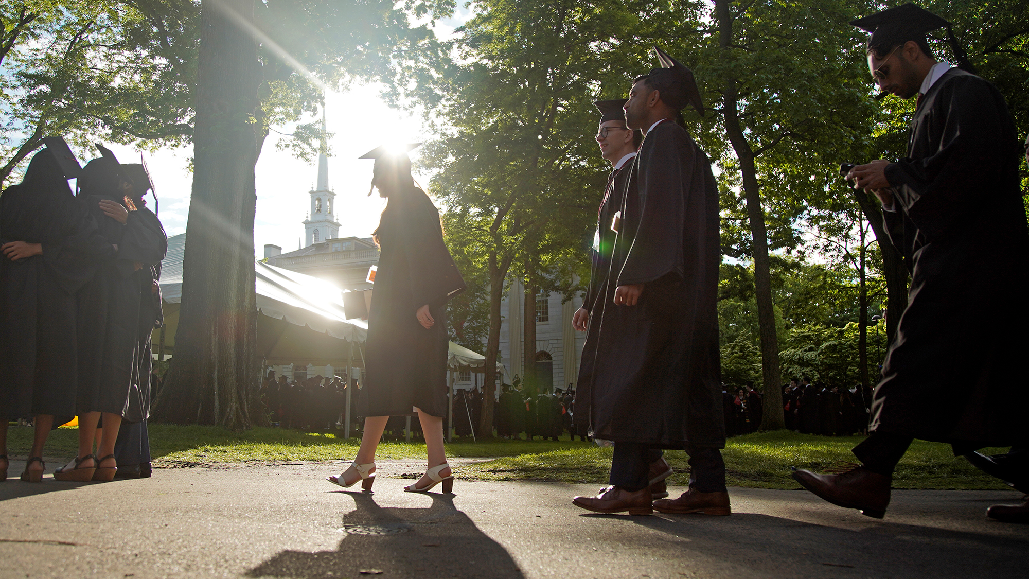 Graduates walk at a Harvard Commencement ceremony held for the classes of 2020 and 2021, May 29, 2022, in Cambridge, Massachusetts.