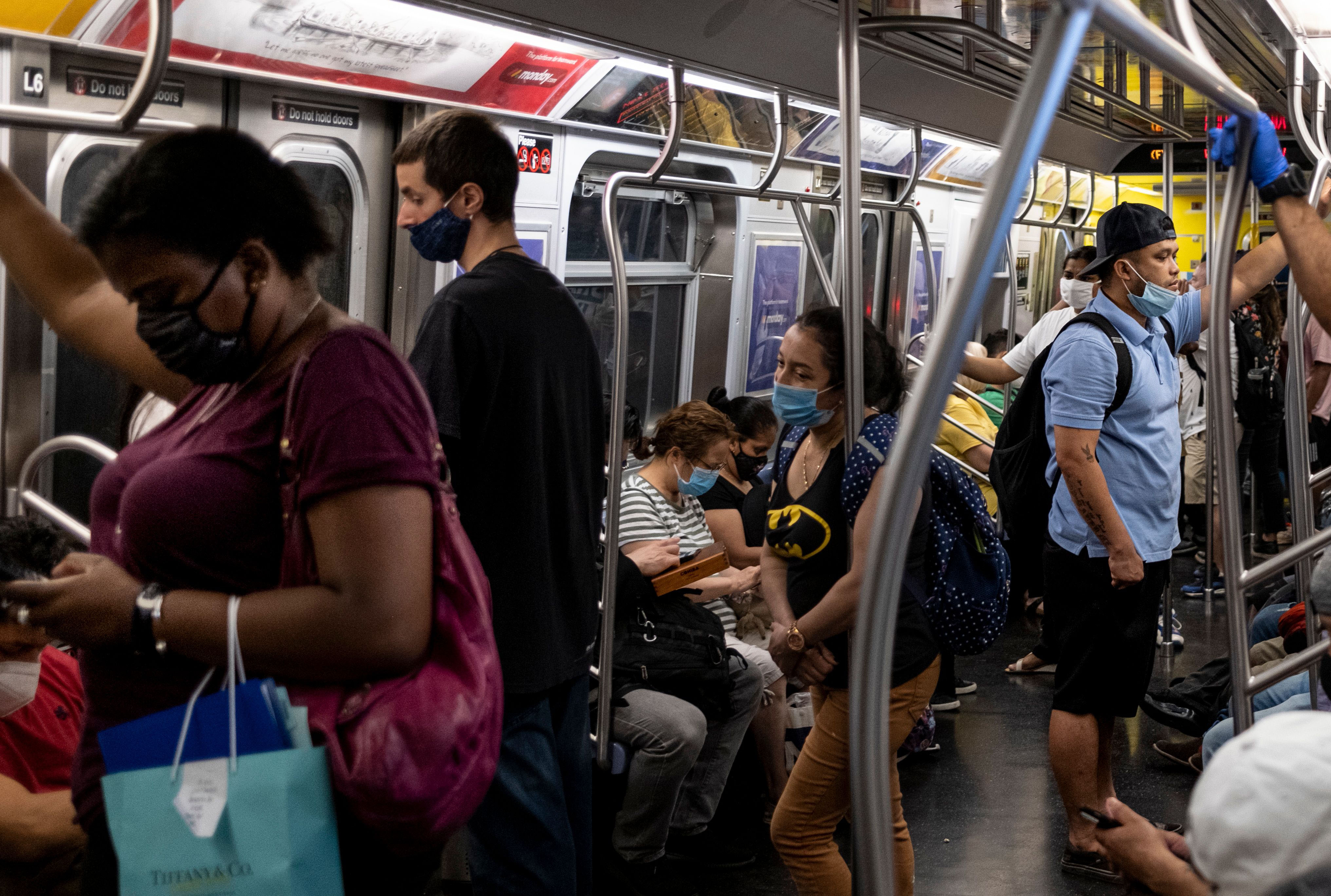 People ride the subway in New York on July 16.