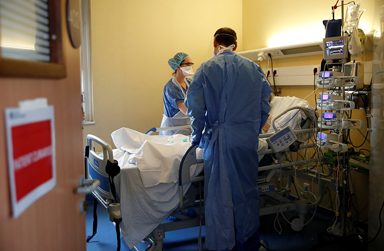A nurse and a doctor tend to an intubated and sedated patient with COVID-19 at the intensive care unit of the Peupliers private hospital in Paris, on Tuesday, April 7.