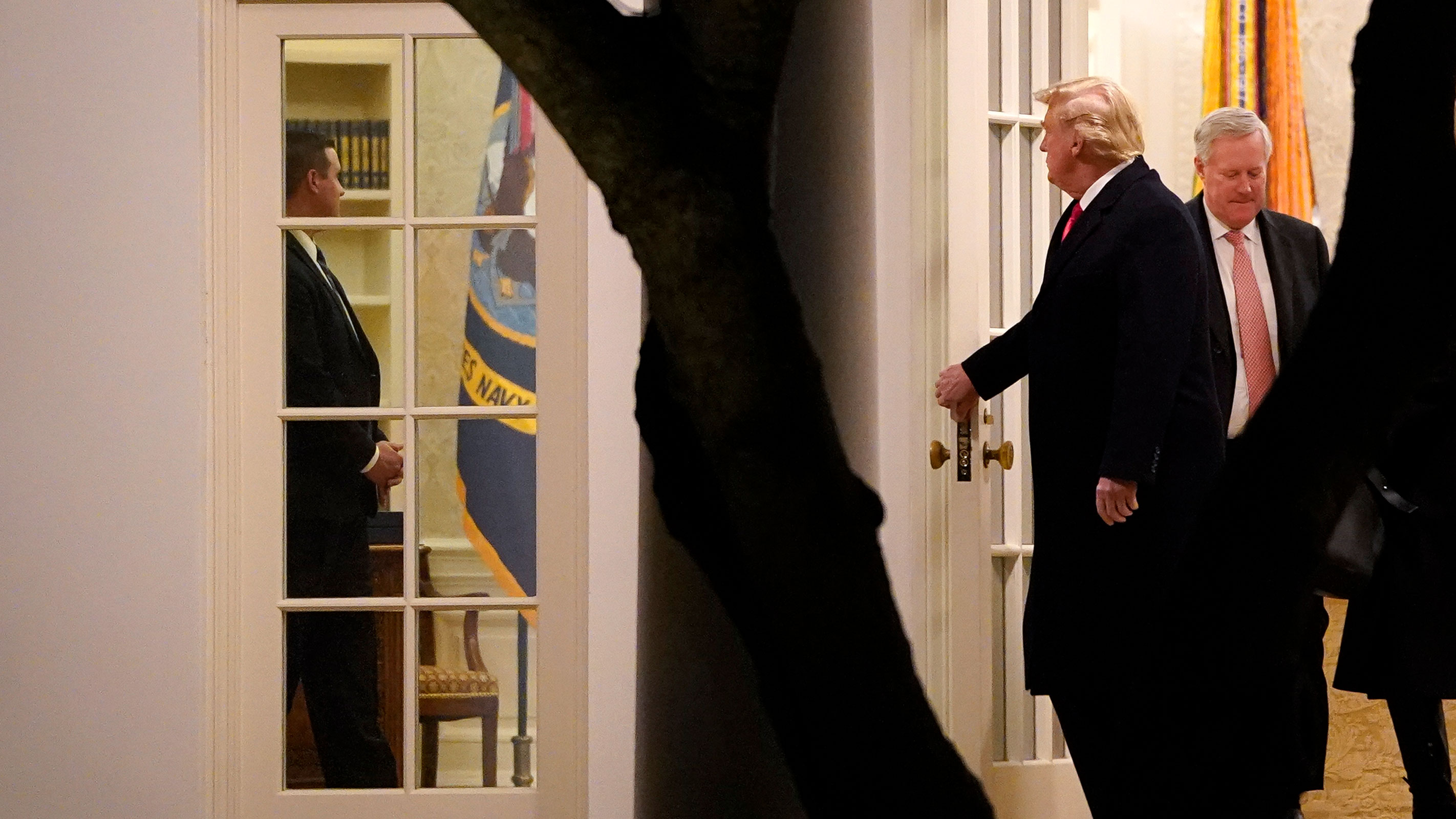 In this January 4, 2021 photo, President Donald Trump and Chief of Staff Mark Meadows exit the Oval Office and walk to Marine One on the South Lawn of the White House in Washington, DC. 