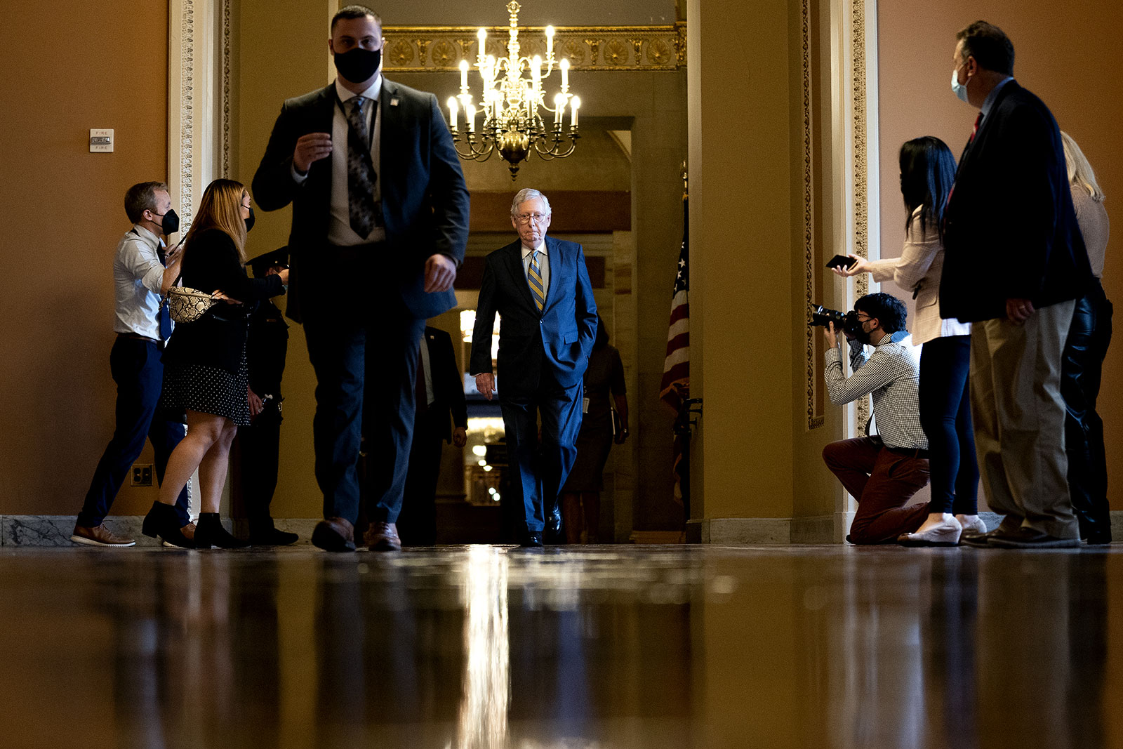 Senate Minority Leader Mitch McConnell, center, walks to the Senate chamber on October 6.