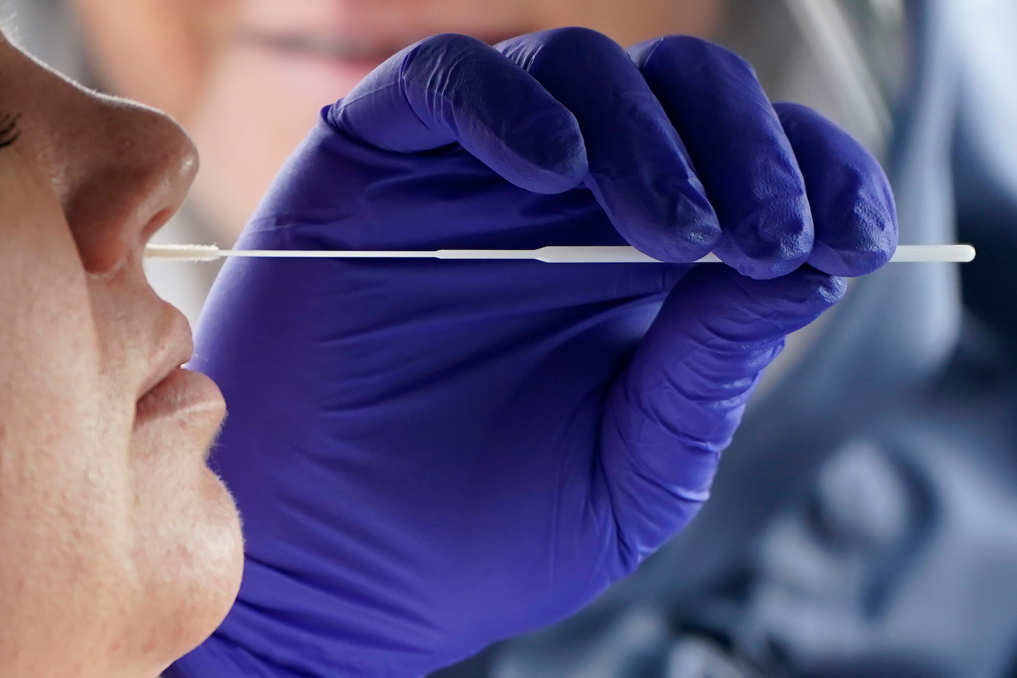 Salt Lake County Health Department public health nurse Lee Cherie Booth performs a coronavirus test outside the Salt Lake County Health Department on October 23 in Salt Lake City. 