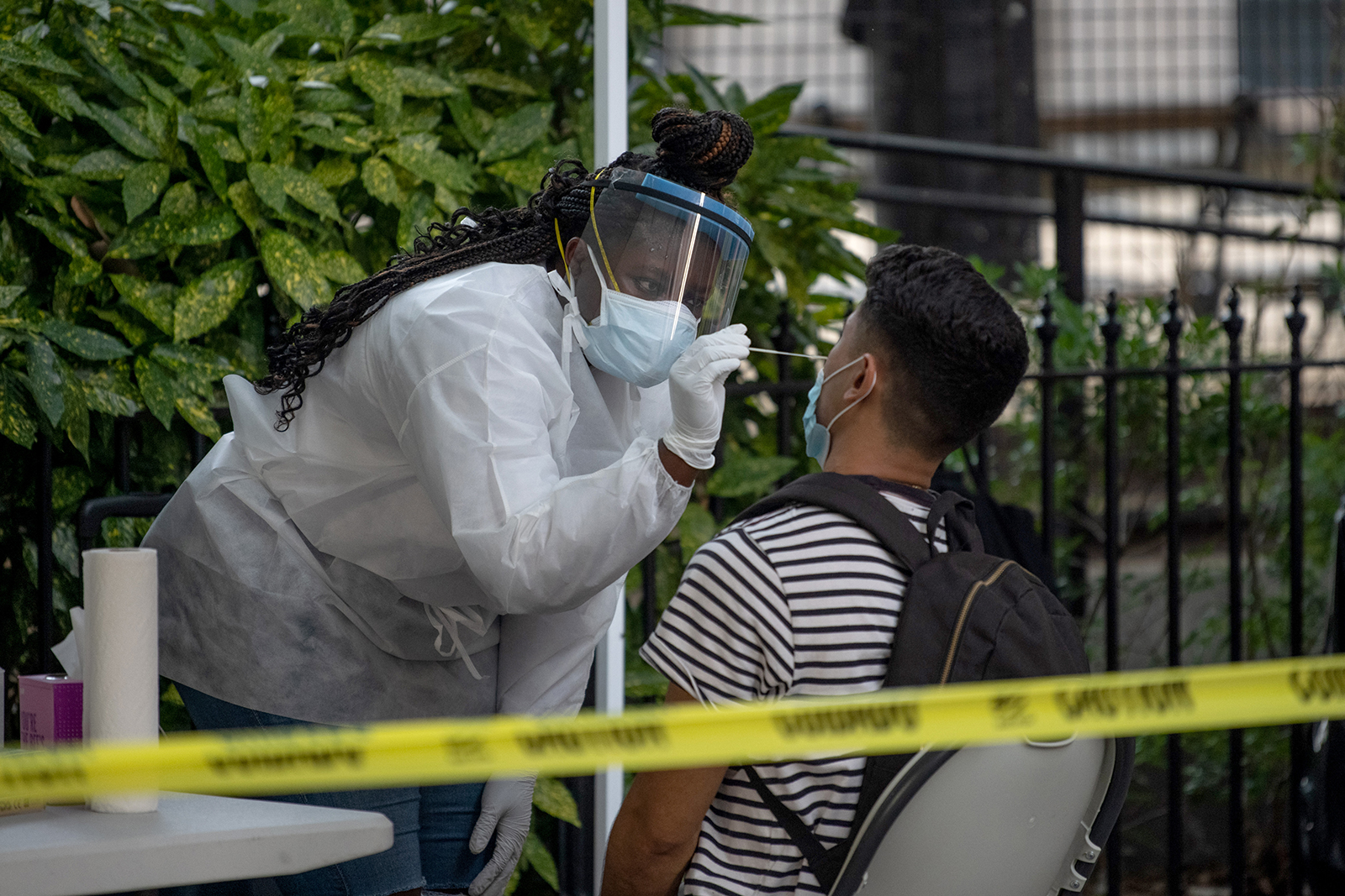 A medical worker wearing PPE administers a nasal swab test at a free coronavirus testing location outside Washington Square Park in New York on July 18. 