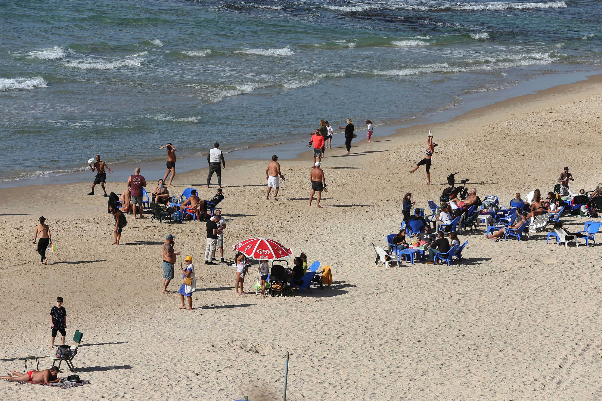 People enjoy themselves on a reopened beach in Tel Aviv, Israel, on February 13, 2021. 