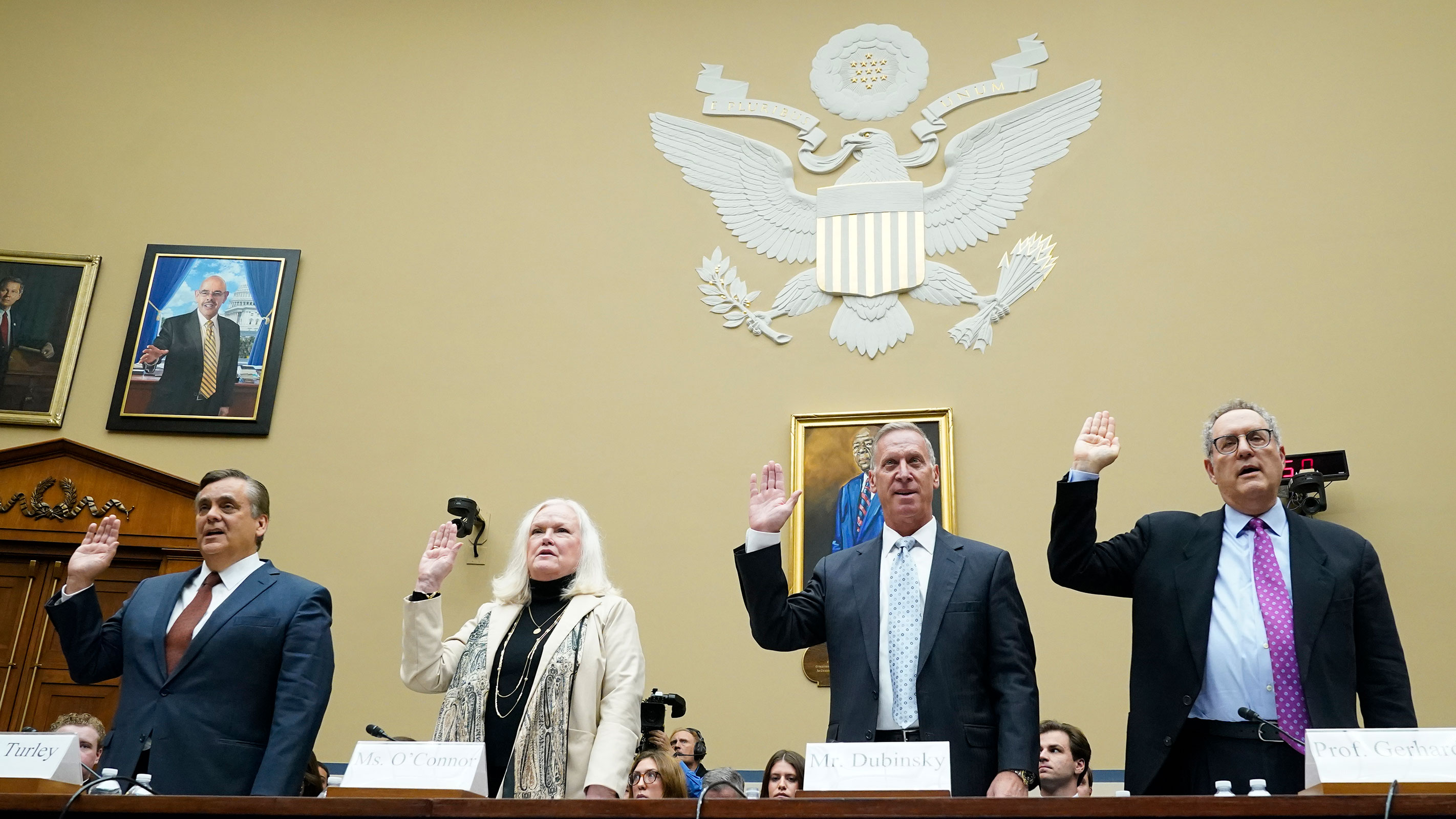 Witnesses are sworn in before the House Oversight Committee impeachment inquiry into President Joe Biden, Thursday, Sept. 28, 2023, on Capitol Hill in Washington, DC. From left are, Jonathan Turley, Shapiro Chair for Public Interest Law at the George Washington University Law School, Eileen O'Connor, former Assistant Attorney General at the Department of Justice, Bruce Dubinsky, with Dubinsky Consulting, and Michael Gerhardt, Burton, Craige Distinguished Professor of Jurisprudence, University of North Carolina at Chapel Hill. 