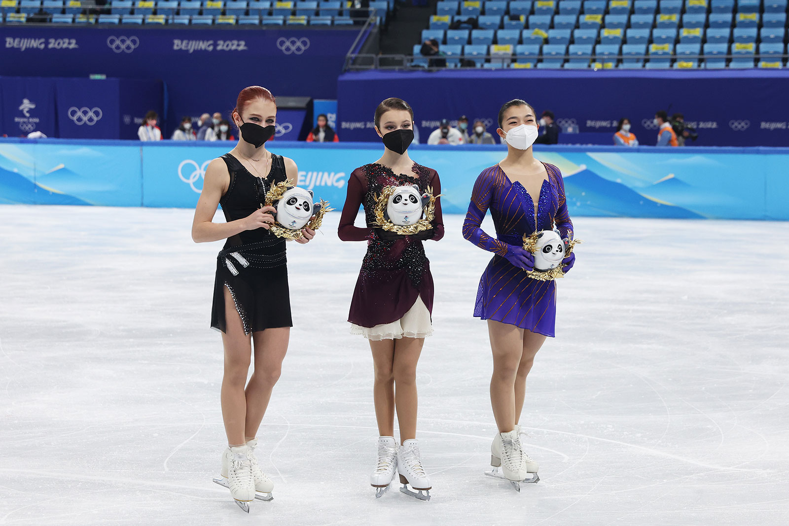 From left, Alexandra Trusova, Anna Shcherbakova and Kaori Sakamoto pose during the flower ceremony following the women's free skating event on February 17.