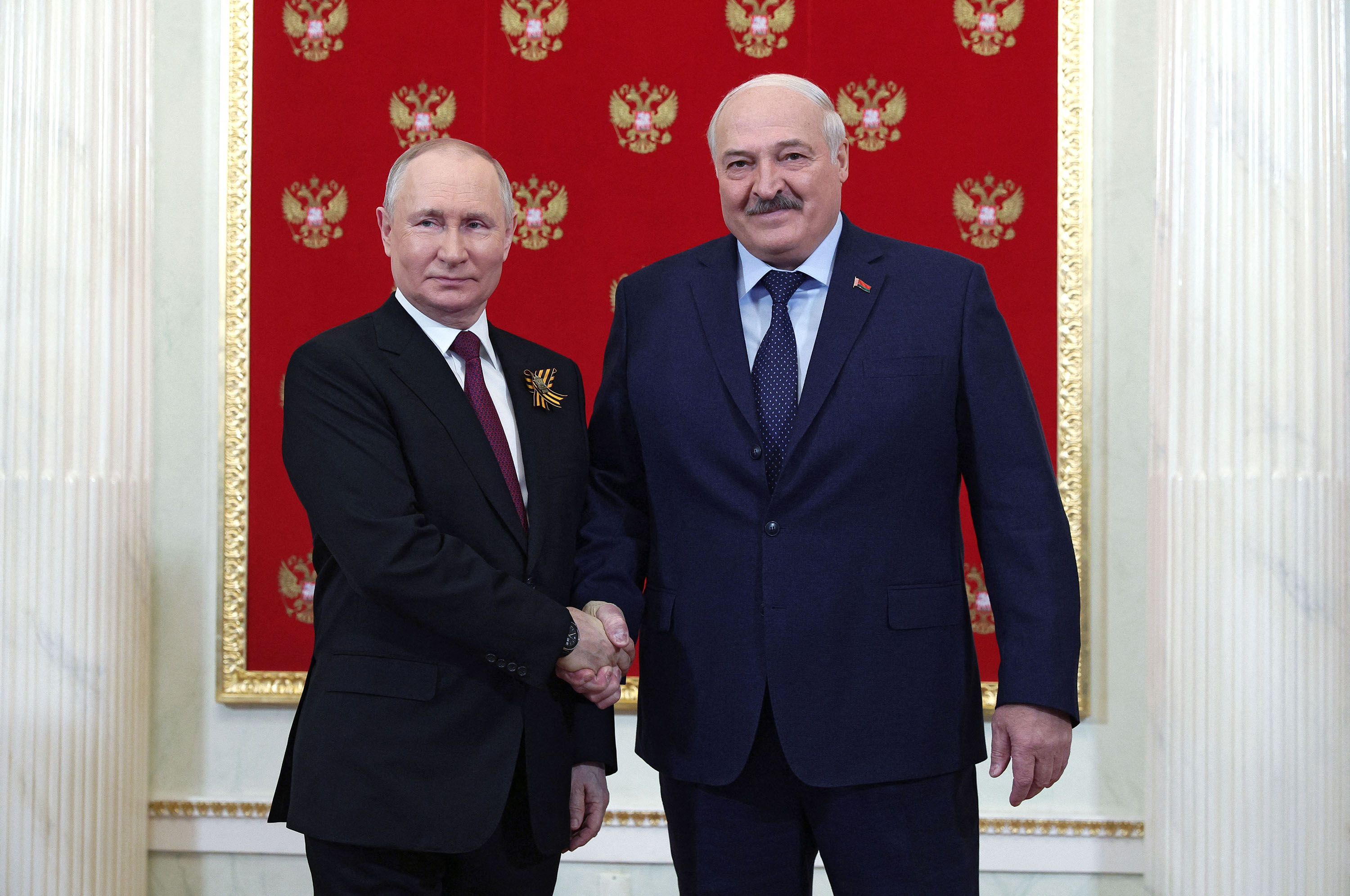 Russian President Vladimir Putin greets Belarus' President Alexander Lukashenko at the Kremlin prior to the Victory Day military parade in Moscow, on May 9. 