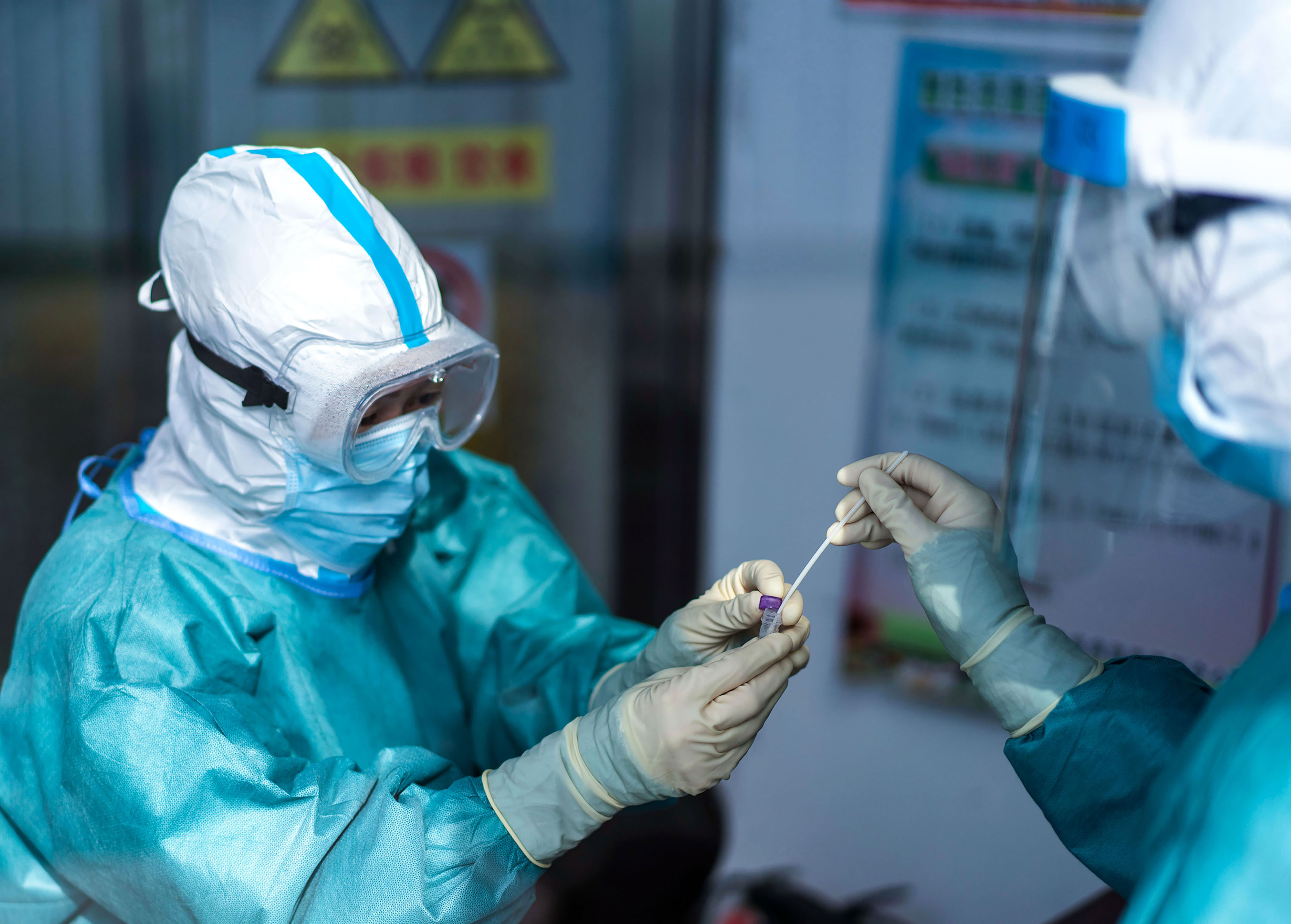Medical workers take swab samples for a coronavirus test at a health services center in Suifenhe, China on April 24.