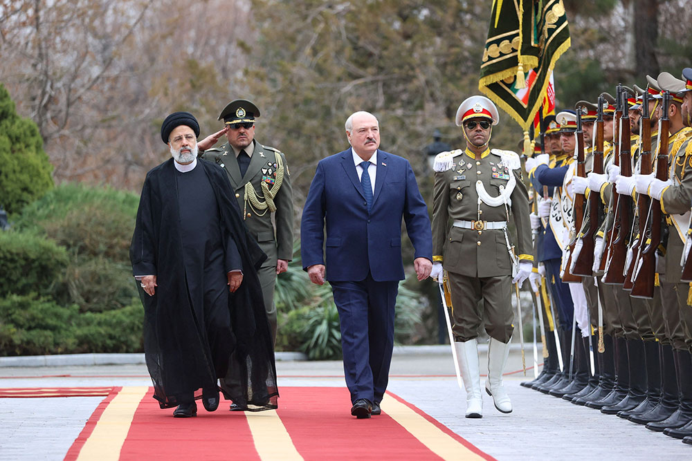 Iranian President Ebrahim Raisi, left,  walks with Belarus President Alexander Lukashenko during a welcoming ceremony in Tehran, Iran, on March 13.