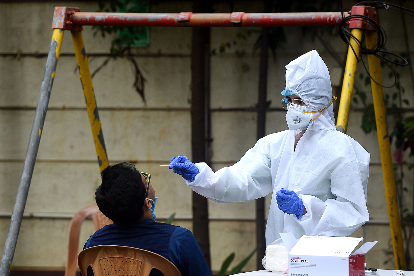 A medical worker takes a nasal swab sample from a man for a Covid-19 test, in Mumbai, India, on September 14.