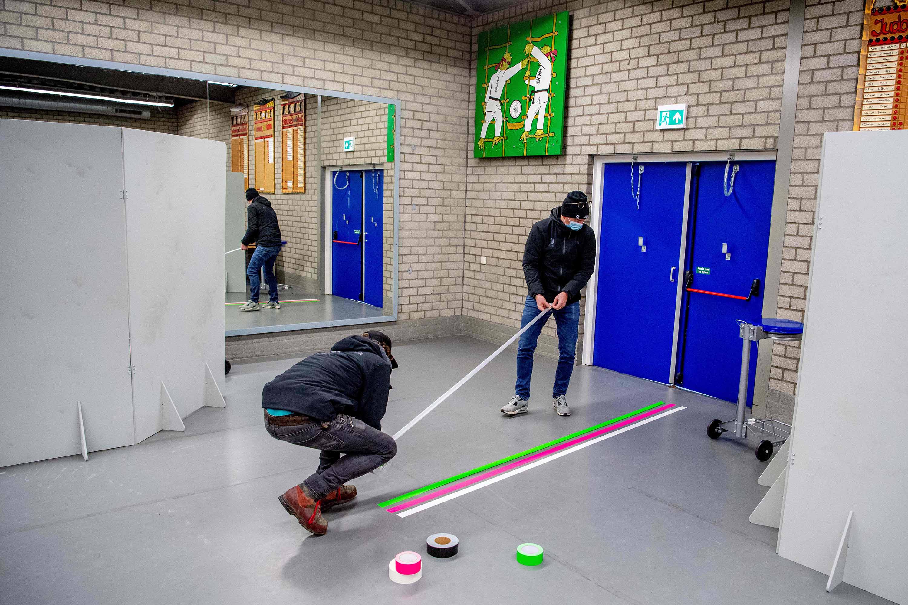 People construct a Covid-19 testing facility at a sports hall in Bergschenhoek, in the municipality of Lansingerland, The Netherlands, on January 12.