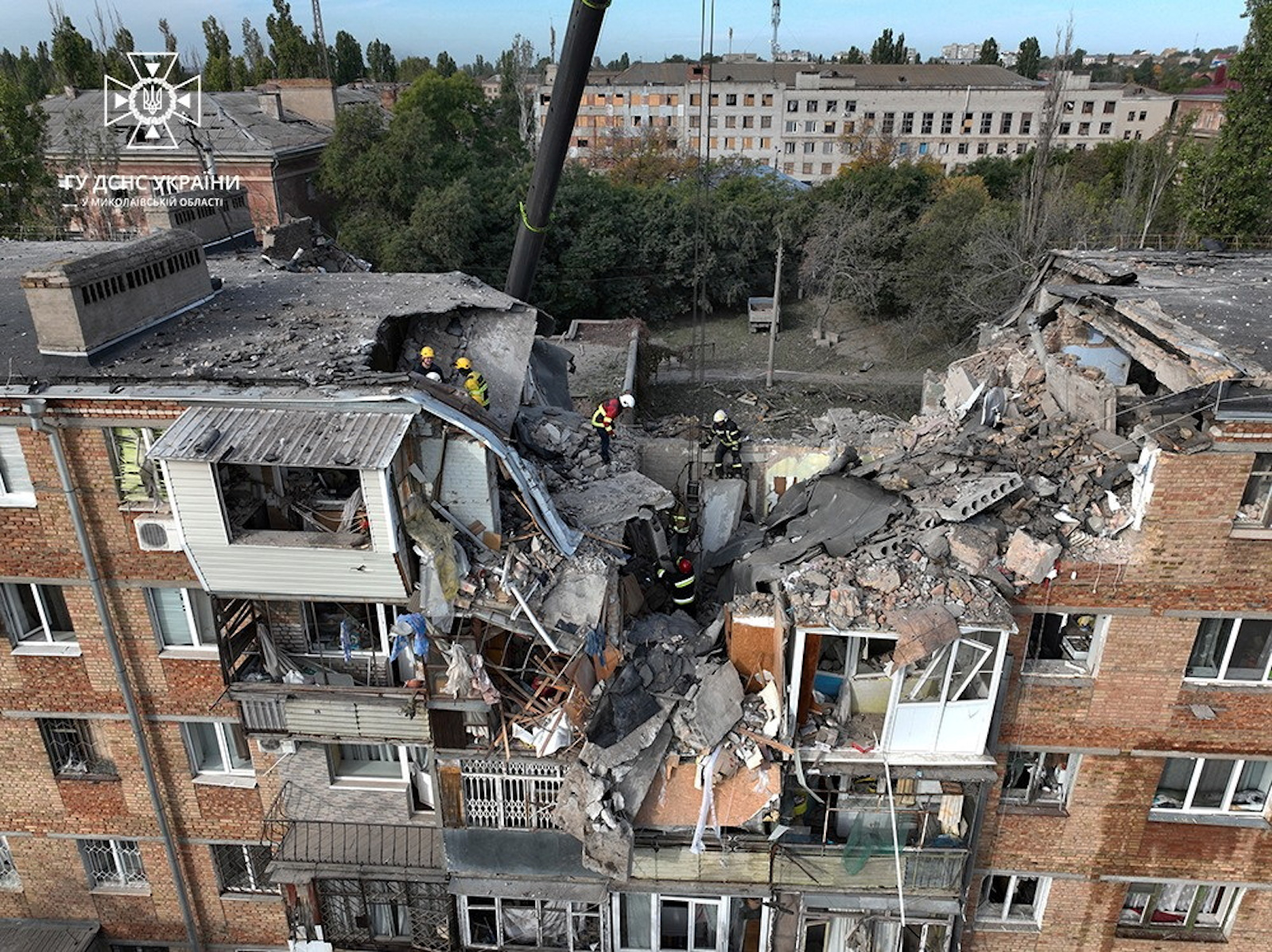 Rescuers work at the site of a residential building heavily damaged during a Russian military attack in Mykolaiv on October 13.