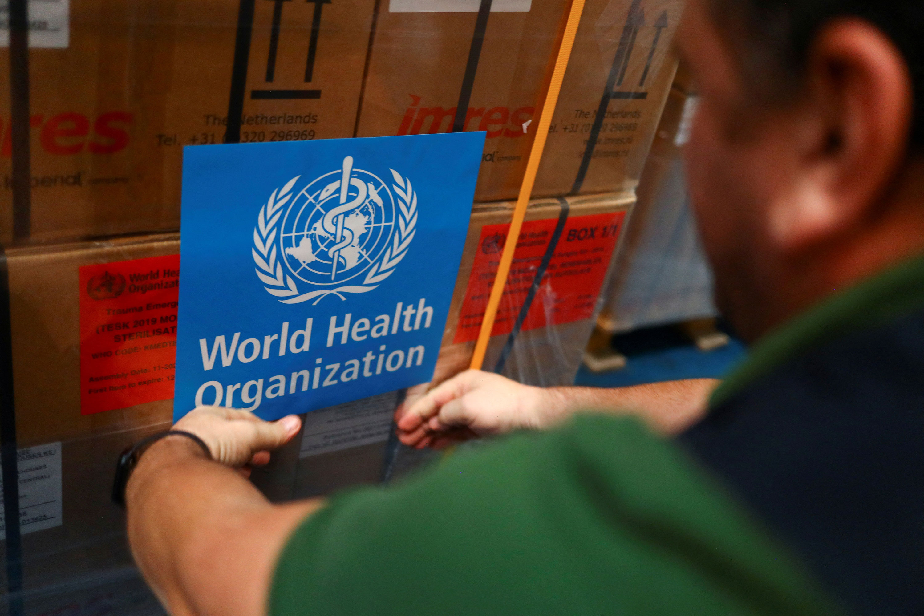 A World Health Organization employee prepares humanitarian aid to be sent to Turkey and Syria in Dubai on Tuesday.