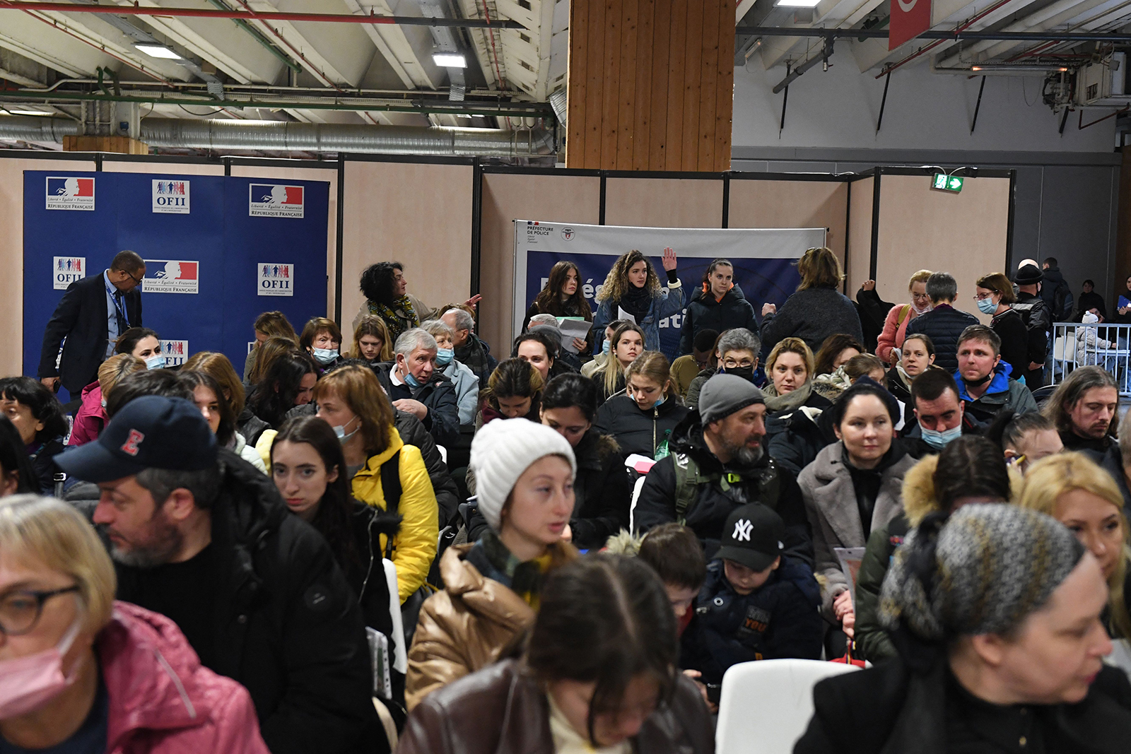 Ukrainians wait to register at a refugee welcome center in Paris on March 17.