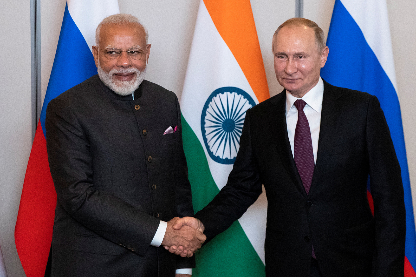 Vladimir Putin, right, shakes hands with Narendra Modi during a meeting in Brasilia, Brazil, on November 13, 2019. 