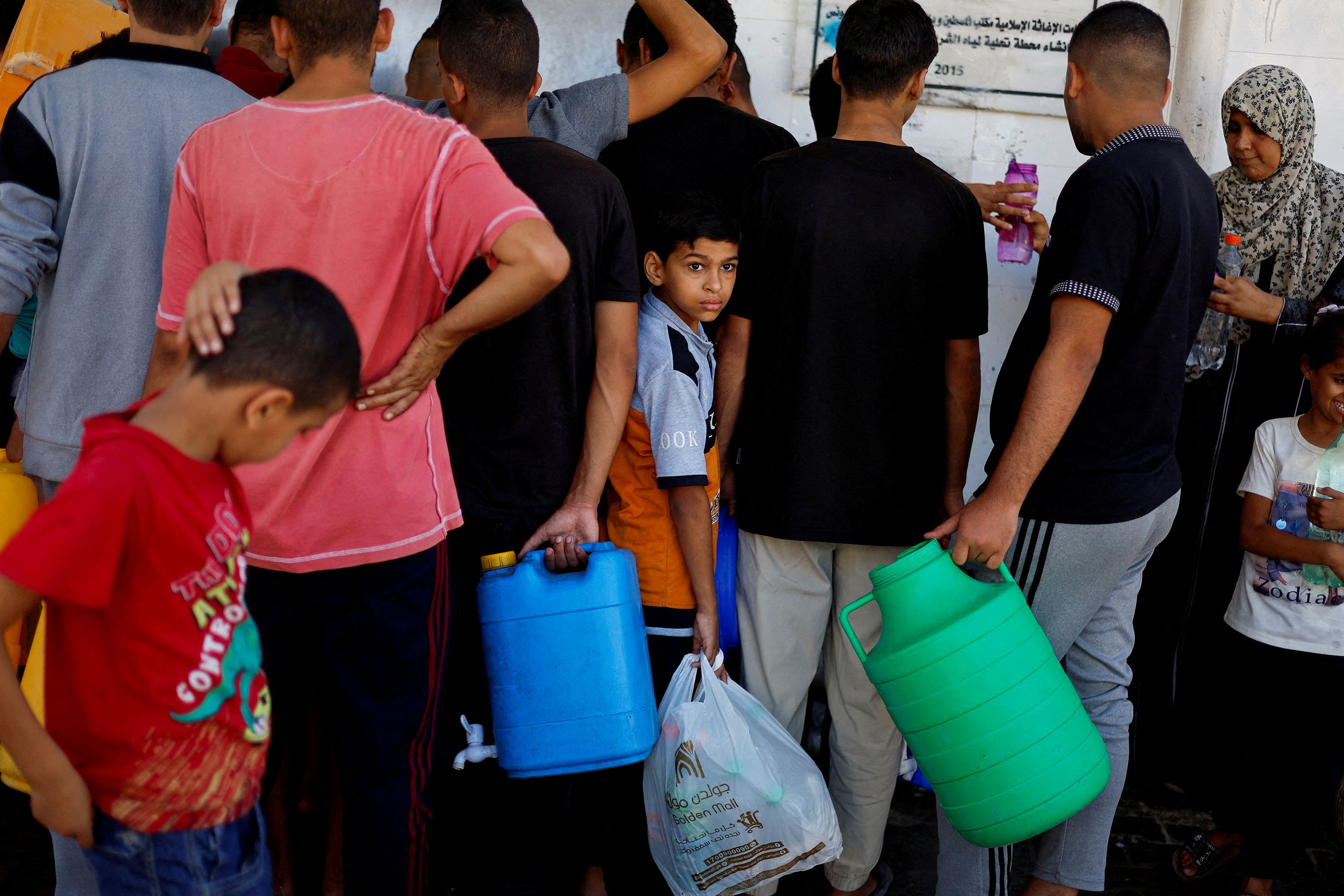 People gather to collect water in Khan Younis, Gaza, on October 15. 