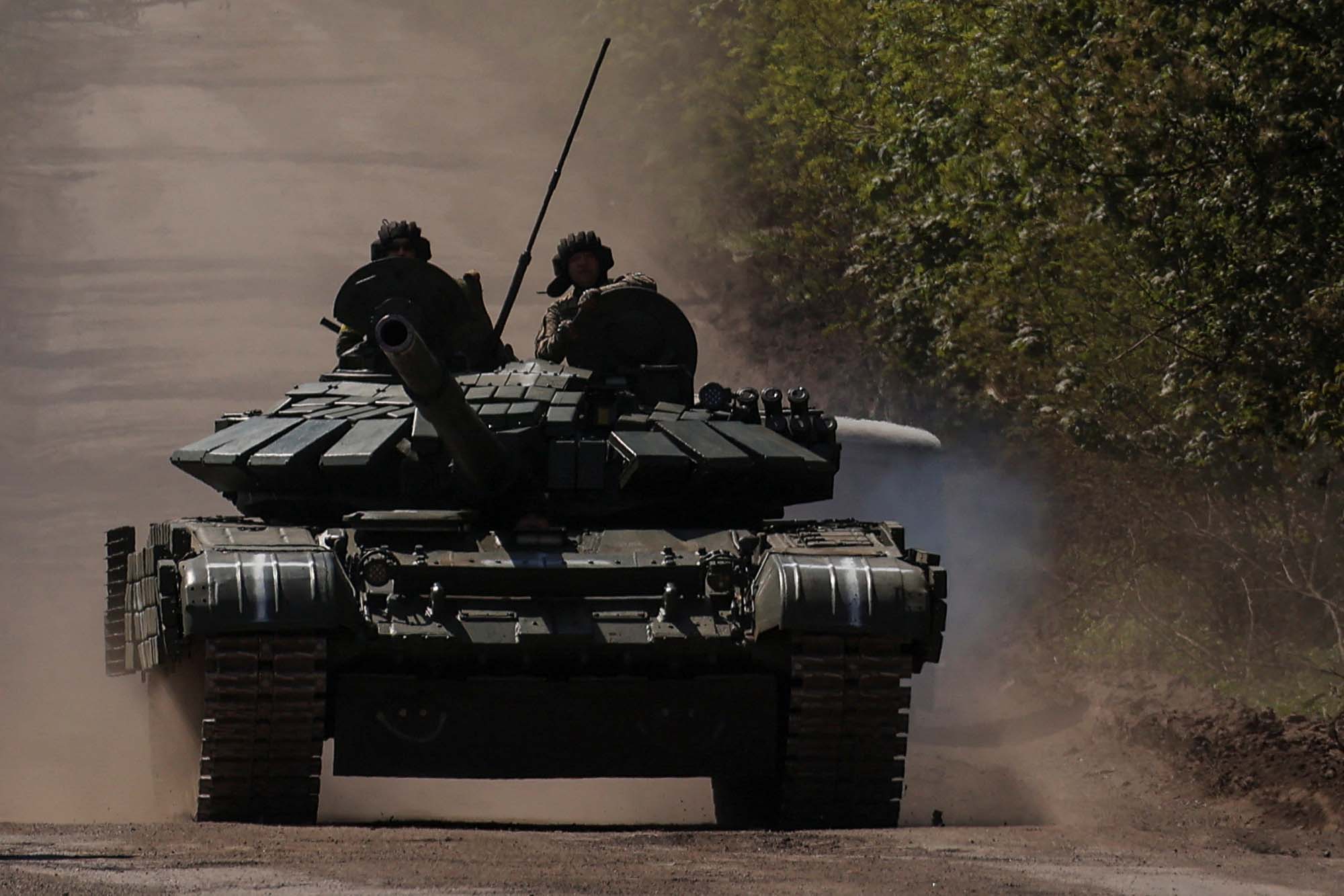 Ukrainian servicemen ride atop a tank on a road to the frontline town of Bakhmut, Ukraine, on May 12. 