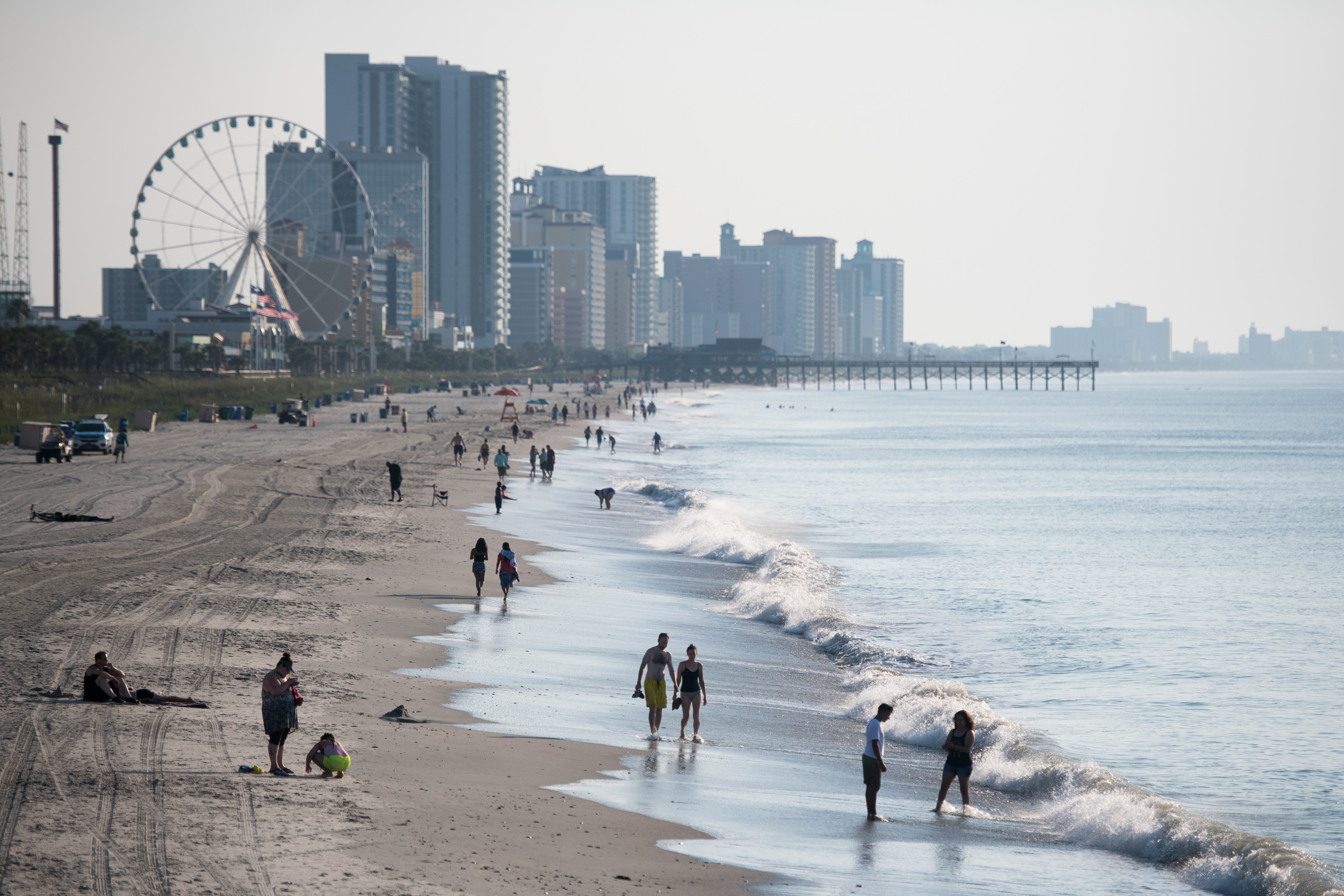 People walk along the beach on the morning of July 4 in Myrtle Beach, South Carolina.