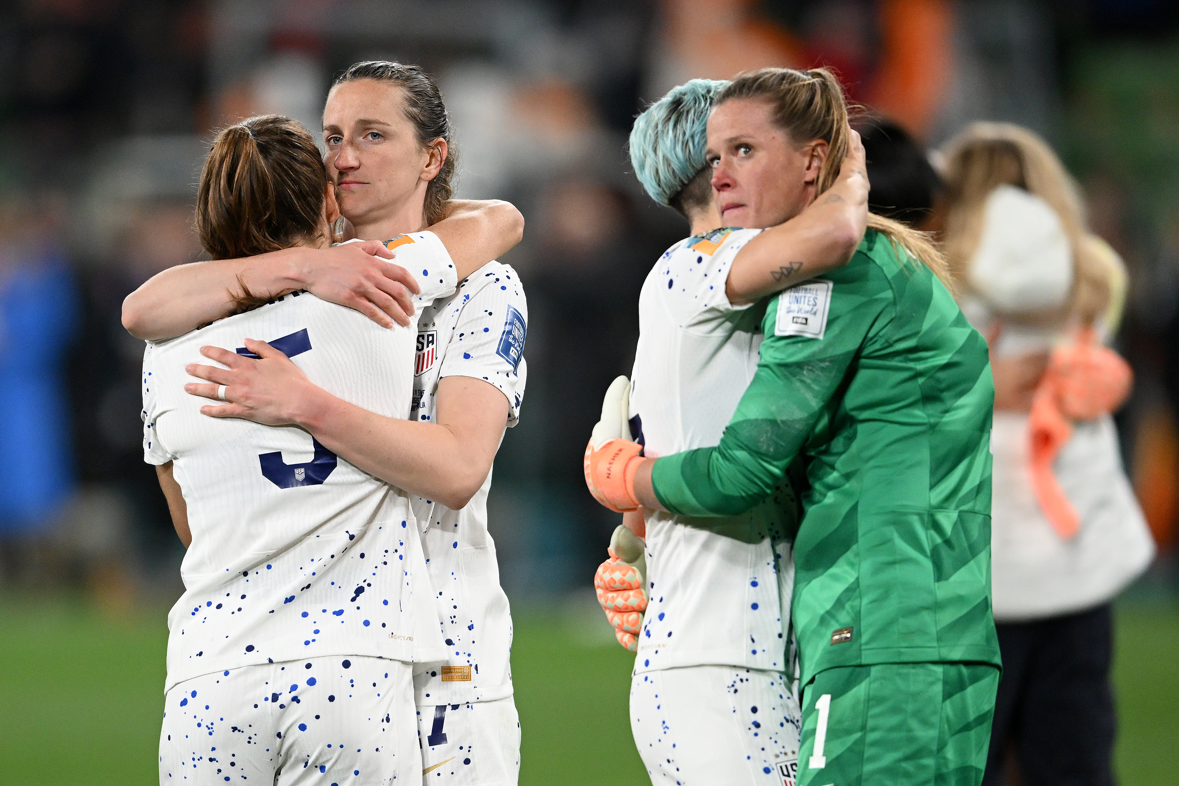 US goalkeeper Alyssa Naeher, right, hugs teammate Megan Rapinoe as Andi Sullivan, second from left, comforts Kelley O'Hara after their team was eliminated by Sweden.