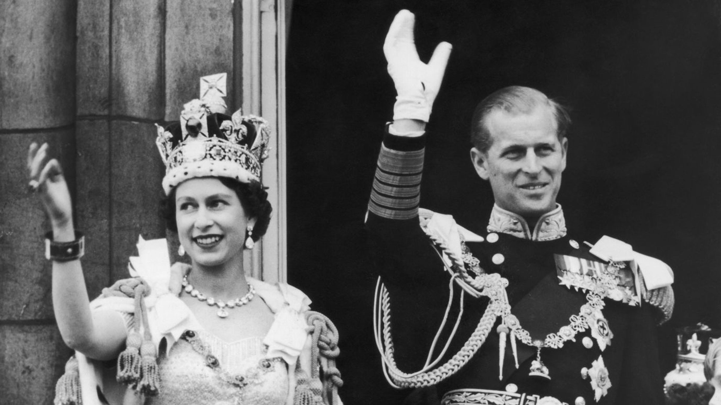 The Queen and Prince Philip wave to crowds from the balcony of Buckingham Palace after the coronation.